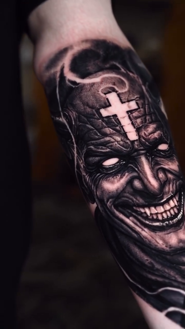 Demonic figure with cross and skull dark realism tattoo by Jake Ross, Mentor, Ohio