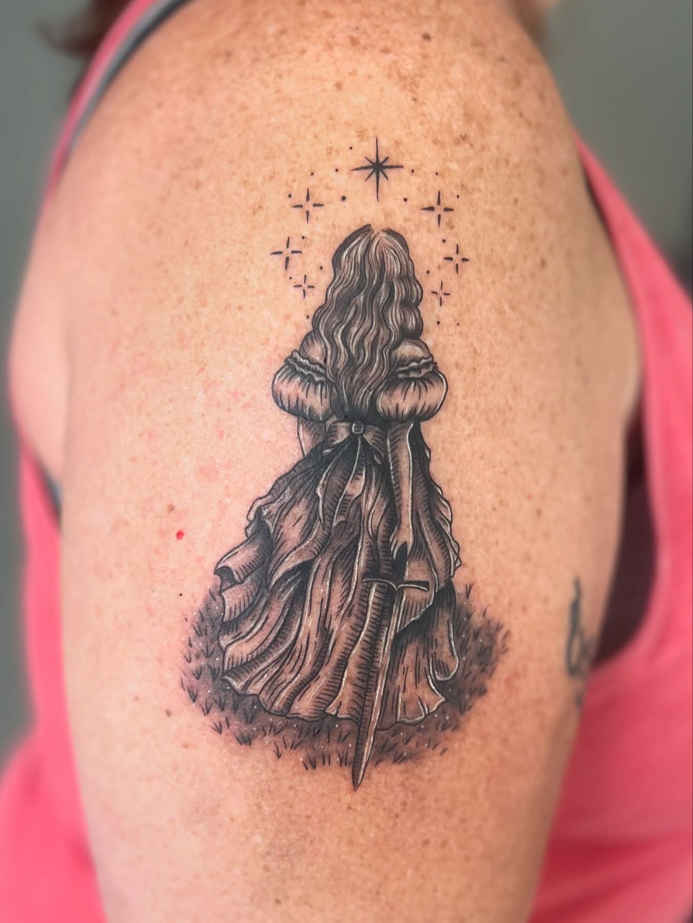 Alice in wonderland black and grey tattoo on the shoulder by Jai Woods