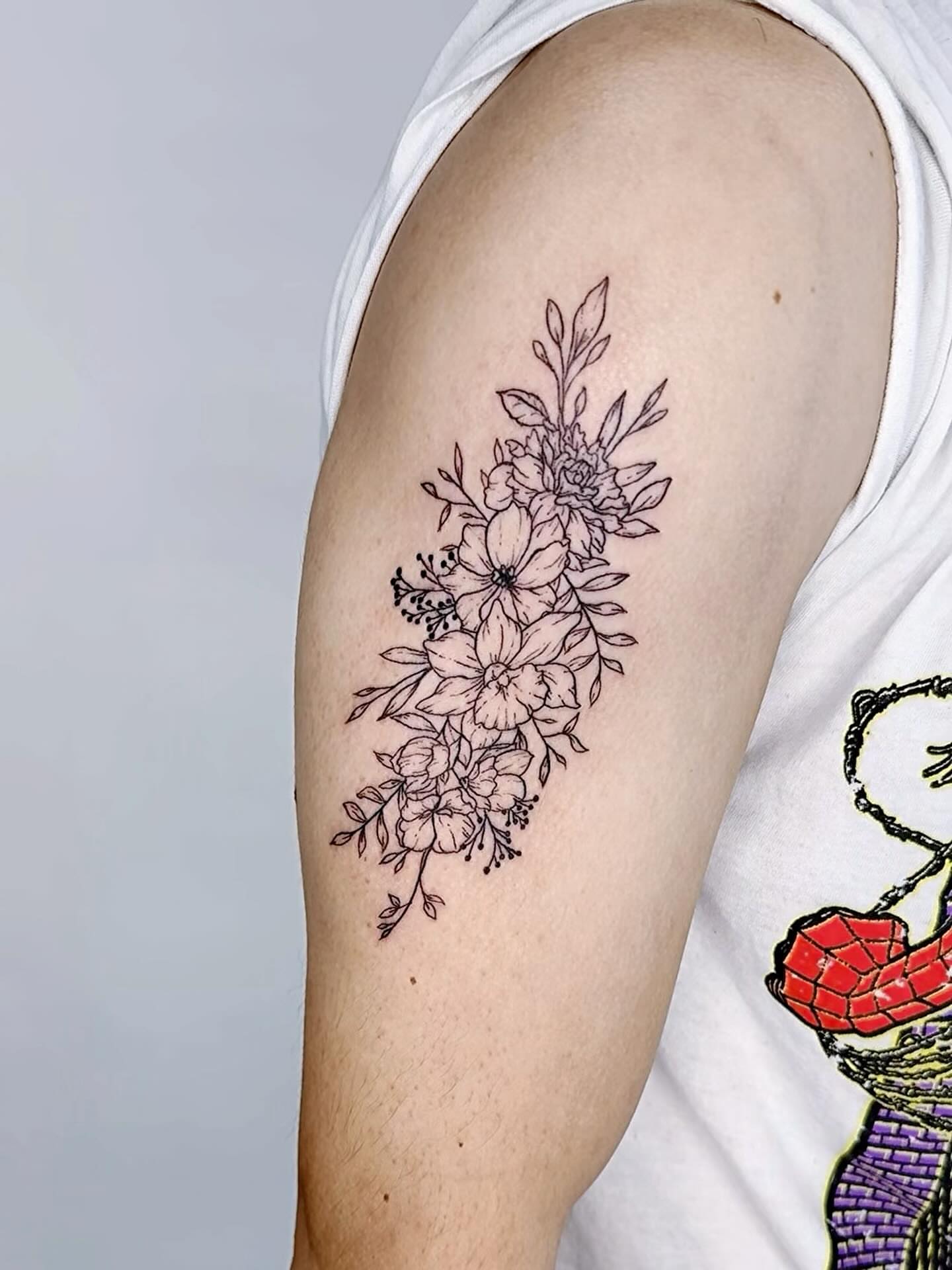 Floral bouquet black and grey tattoo on the forearm by Joey tattoo