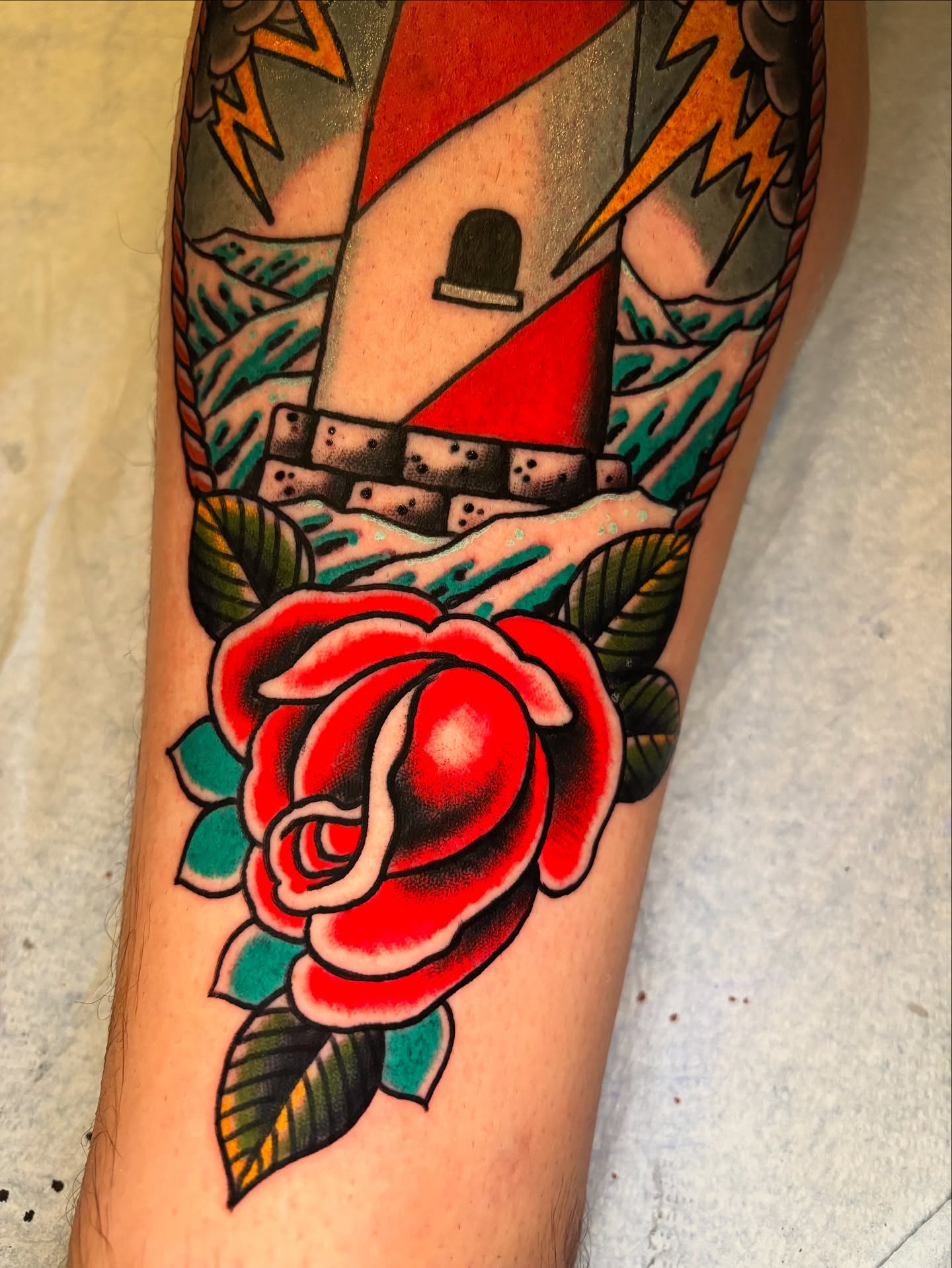 Lighthouse and rose American traditional tattoo on the forearm by Mike Maciejewski:Chicago Tattoo Artist