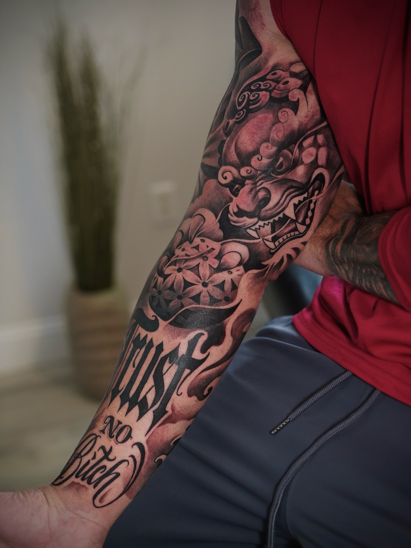 Lion and flowers japanese irezumi tattoo on the forearm by Artem Kunakuzin