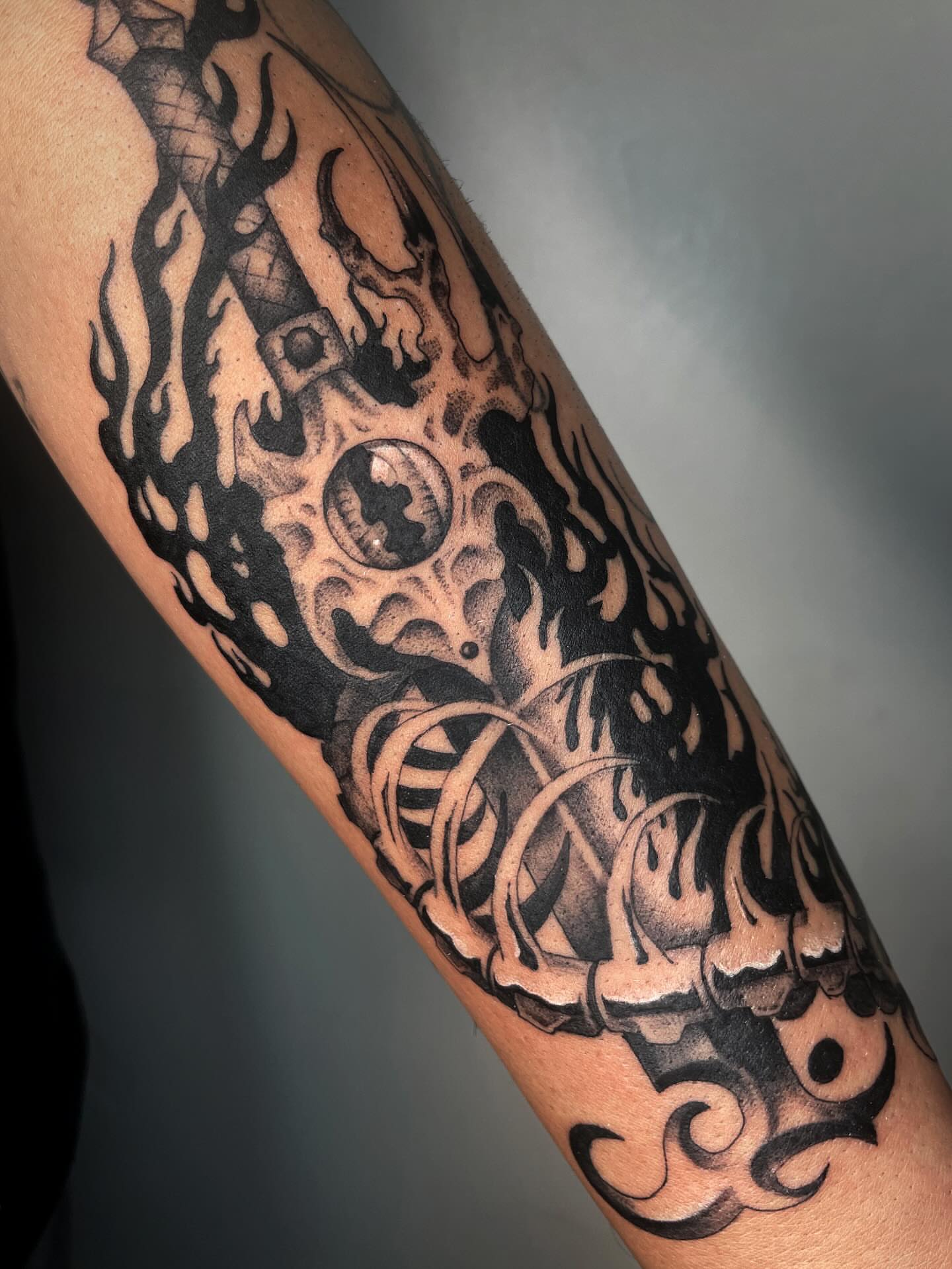 Flame and gear tribal tattoo on the forearm by Vash