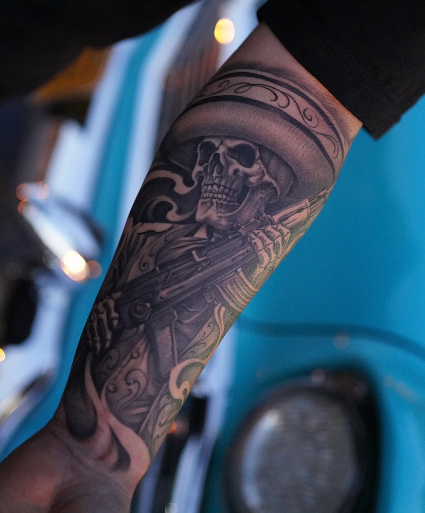 Skull with gun realism tattoo on the forearm by tombstone