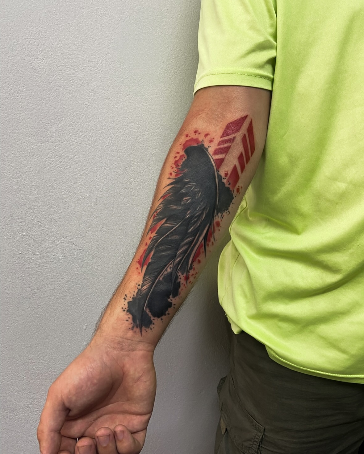 Feather black and grey tattoo on the forearm by Art by Aimee