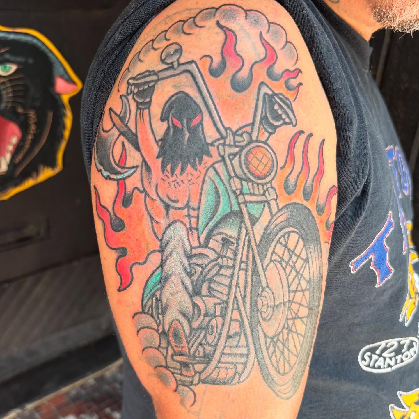 Death on motorcycle American traditional tattoo on the upper arm by @dannydoestattoos