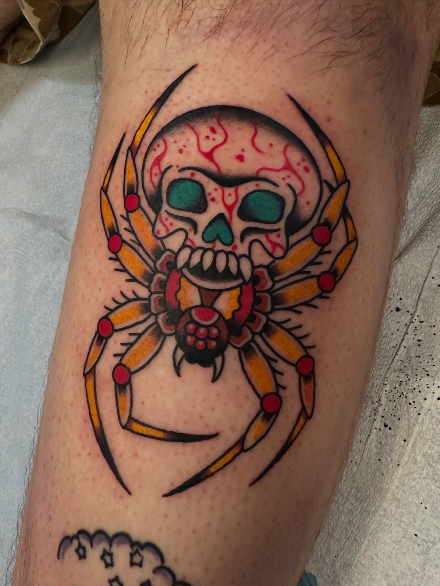 Spider skull American traditional tattoo on the forearm by Emily Masa