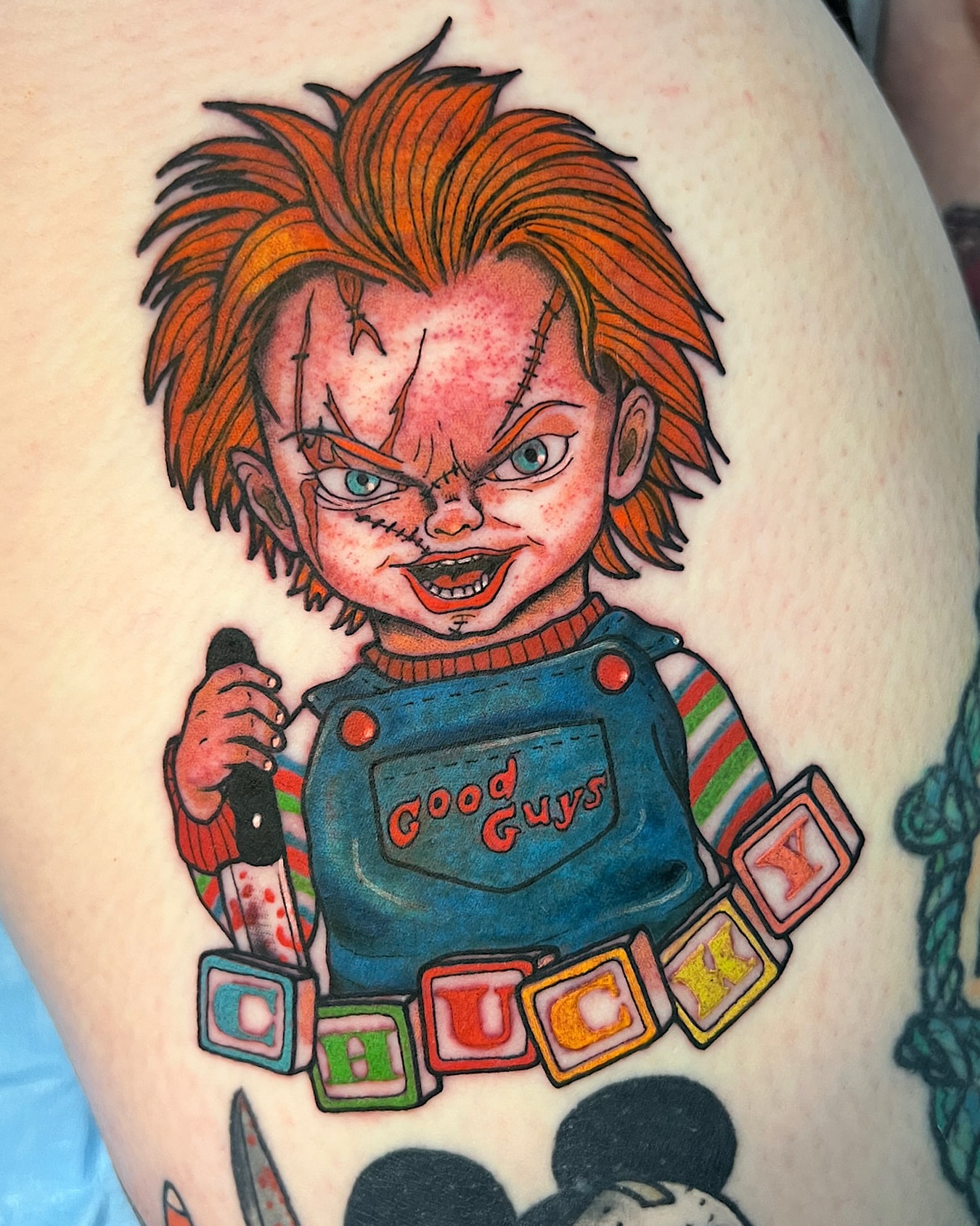 Chucky American traditional tattoo on the thigh by @shannonkeeleyy
