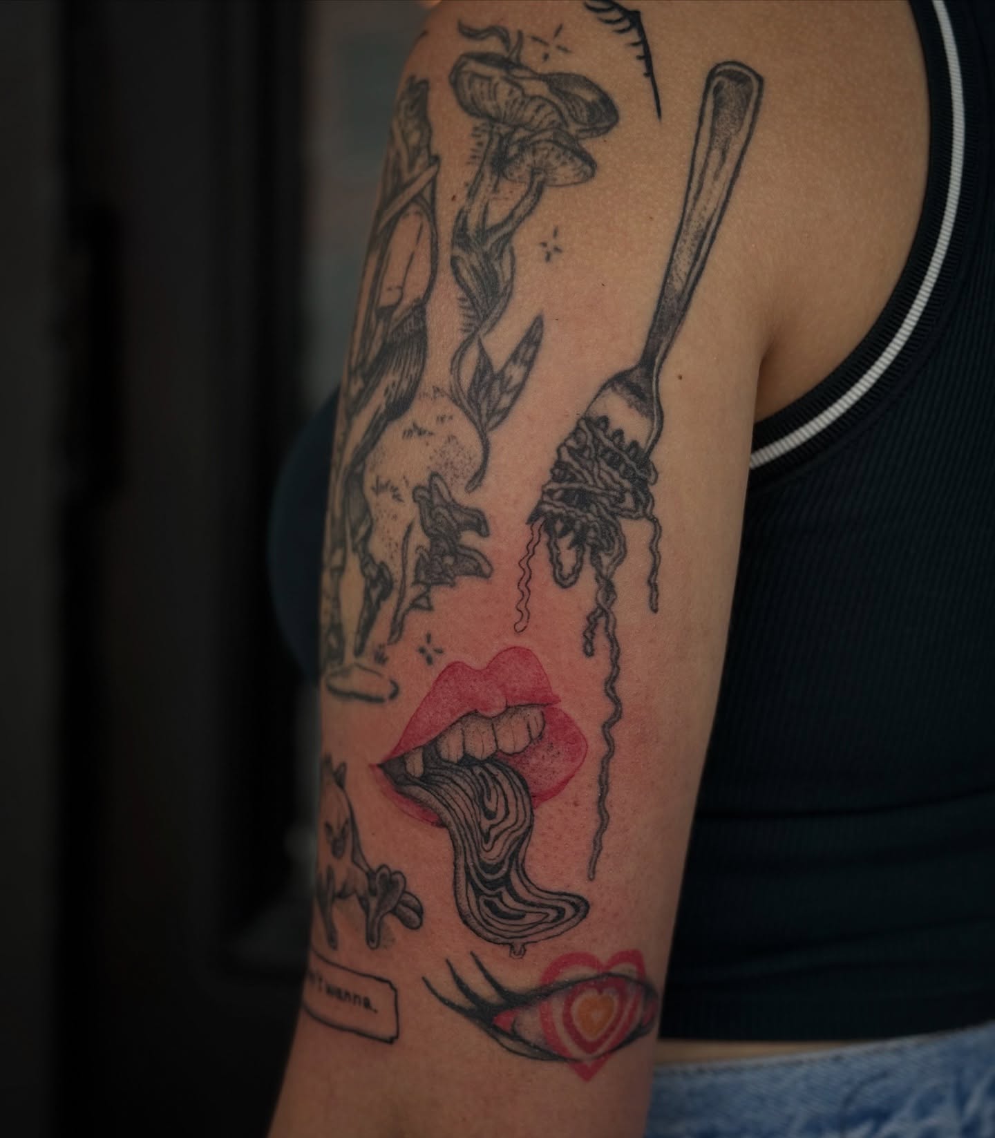 Lips and fork black and grey tattoo on the forearm by 𝙹𝙰𝚉𝚉 𝙲𝙷𝙰𝙾