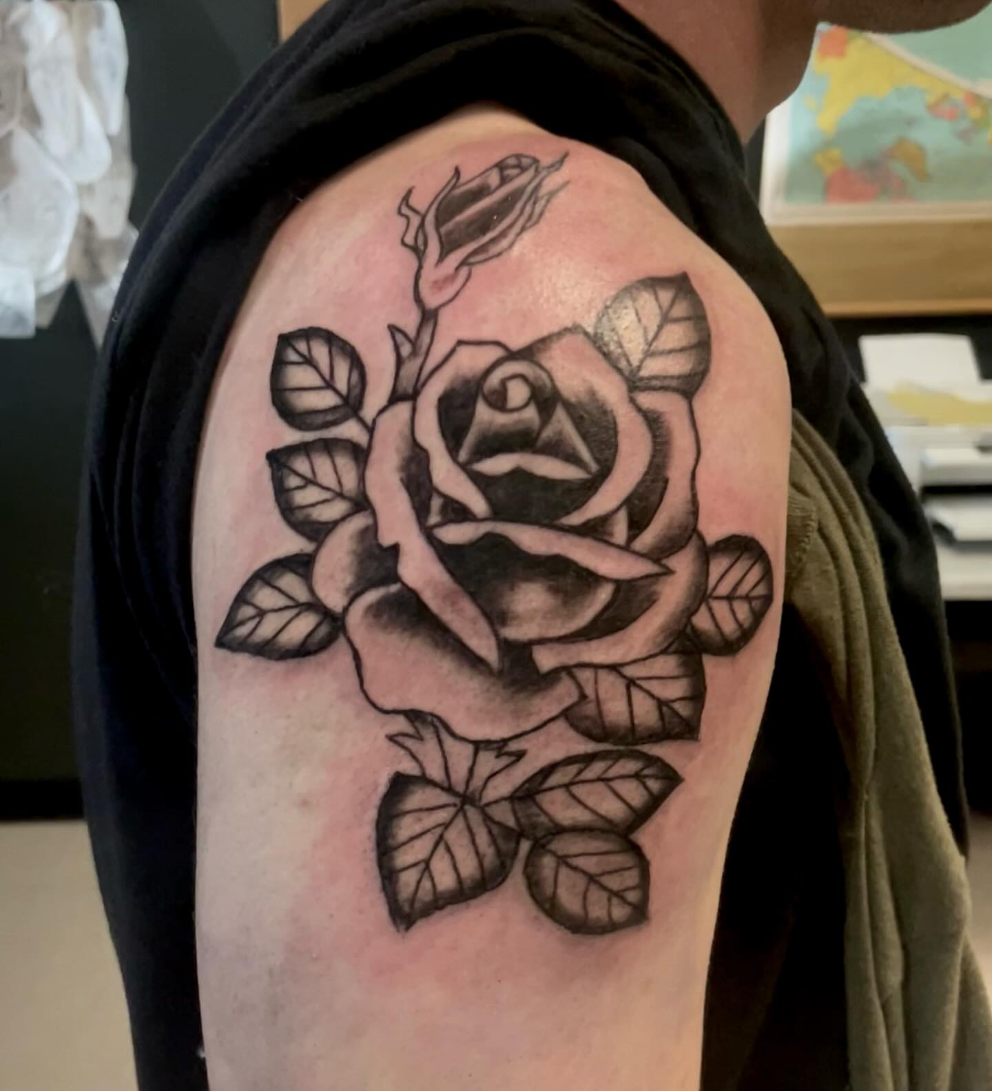 Rose black and grey tattoo on the shoulder by Logan Casimir