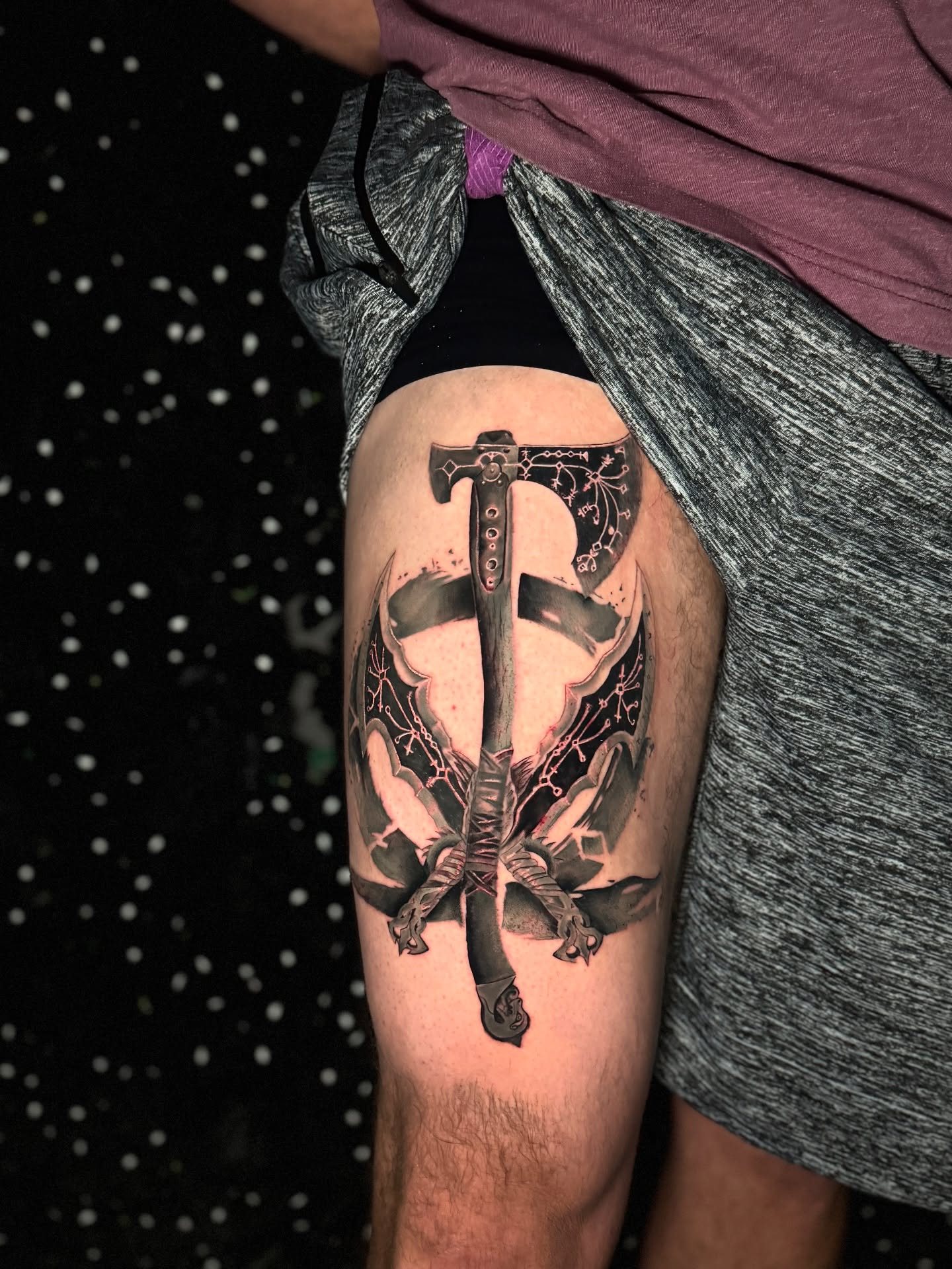 Sword and shield black and grey tattoo on the thigh by Tattoo Artist