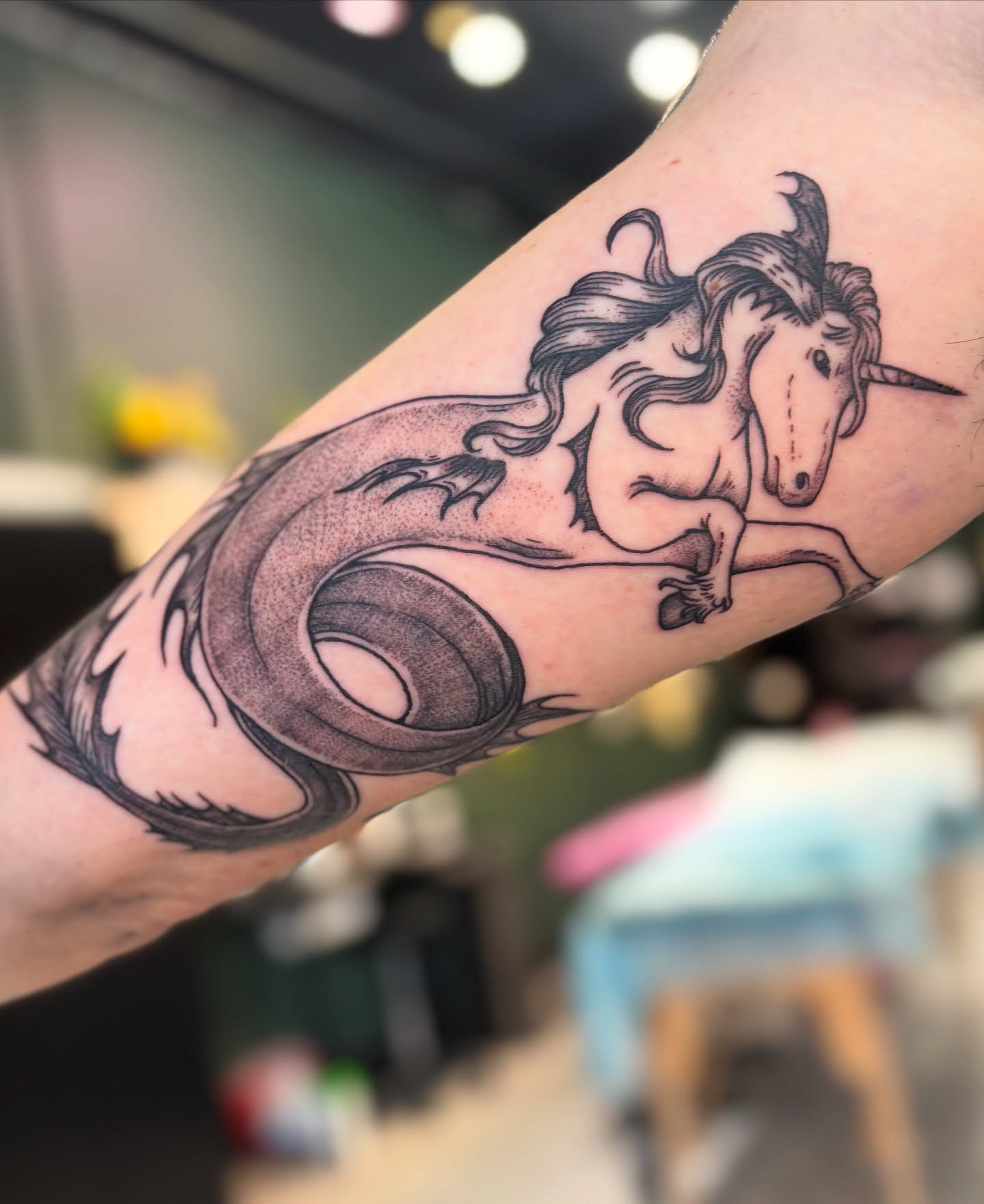 Unicorn black and grey tattoo on the forearm by Meg Ingersoll