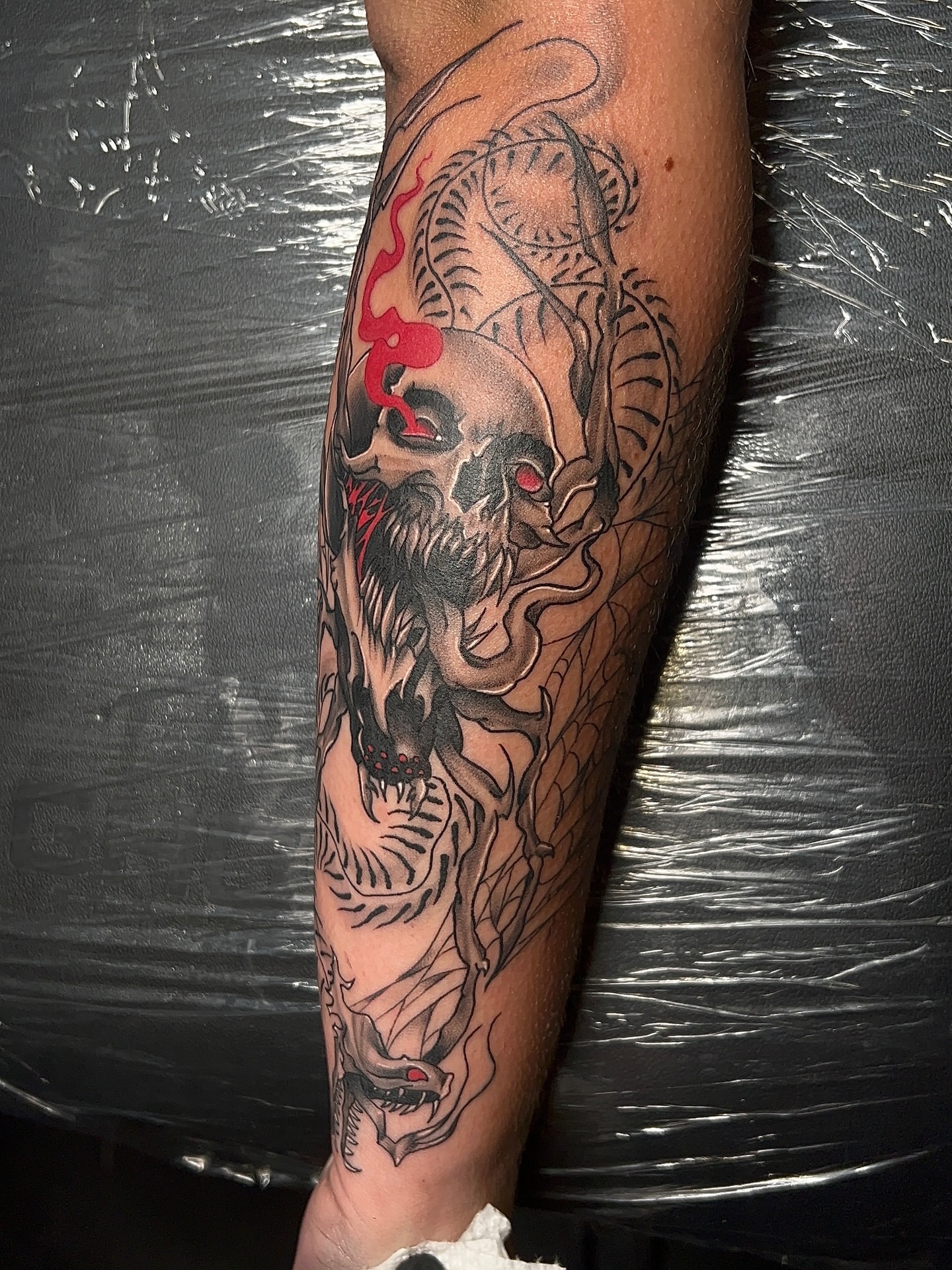 Skull and dragon japanese irezumi tattoo on the forearm by Denis Seregin