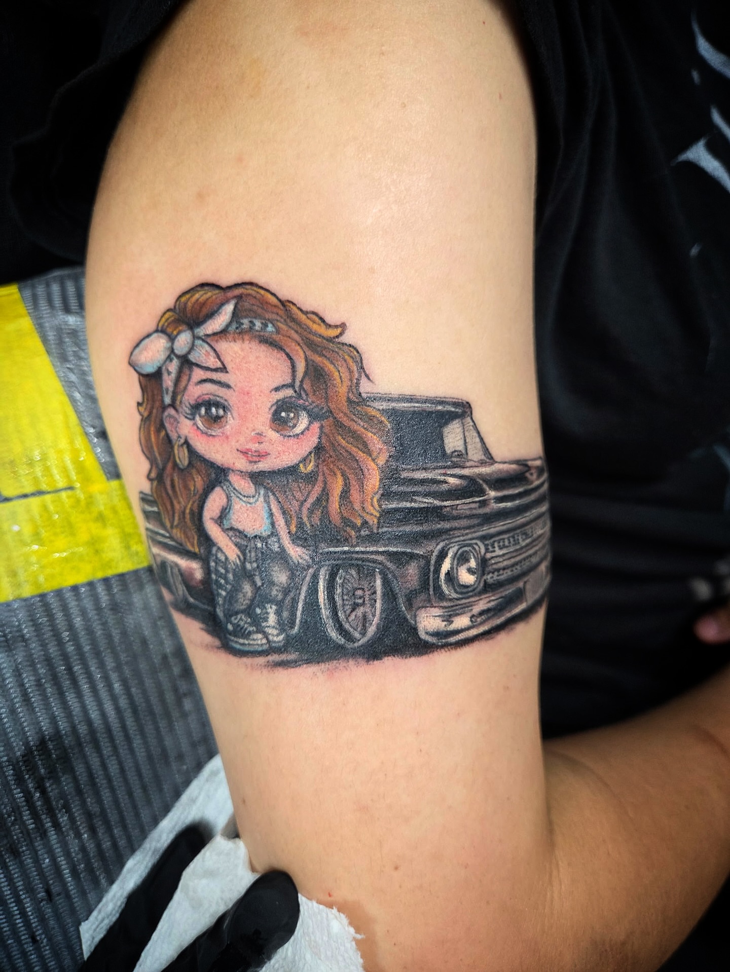 Girl and car realism tattoo on the forearm by Christa Martinez