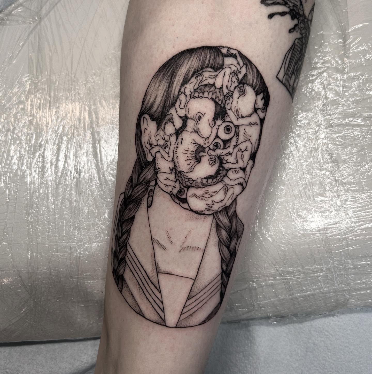 Woman with surrealistic head surrealism tattoo on the forearm by Nikki Power