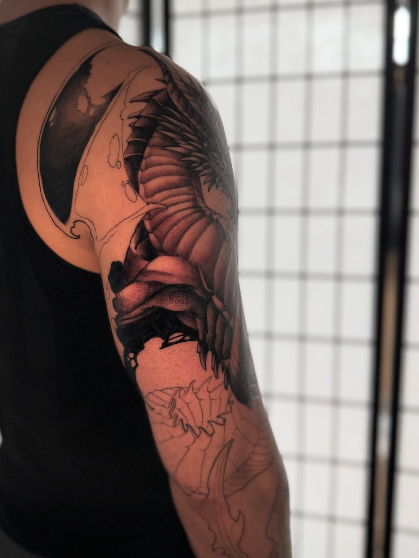 Dragon realism tattoo on the upper arm by Carlos Valdes ✨ Tattoo Artist in Tampa FL