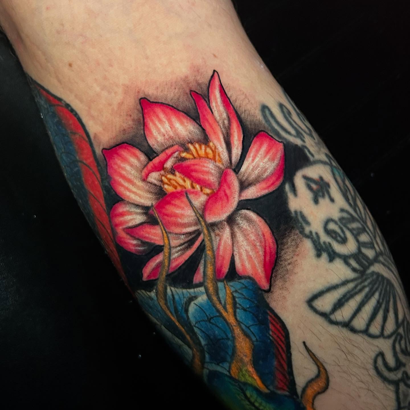 Lotus flower realism tattoo on the forearm by Adrian Michigan Tattoo Artist