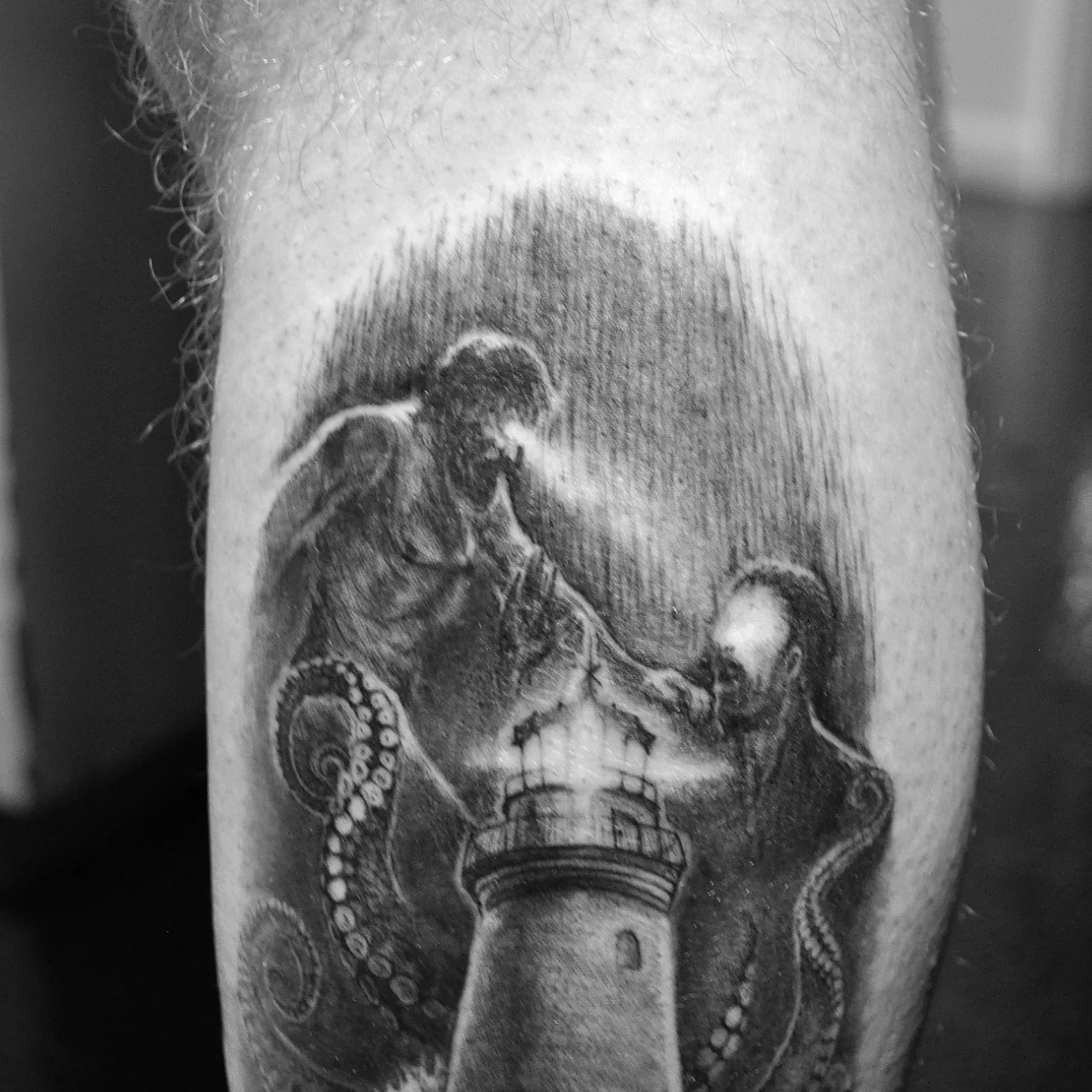 Lighthouse and octopus realism tattoo on the forearm by Bek Artz