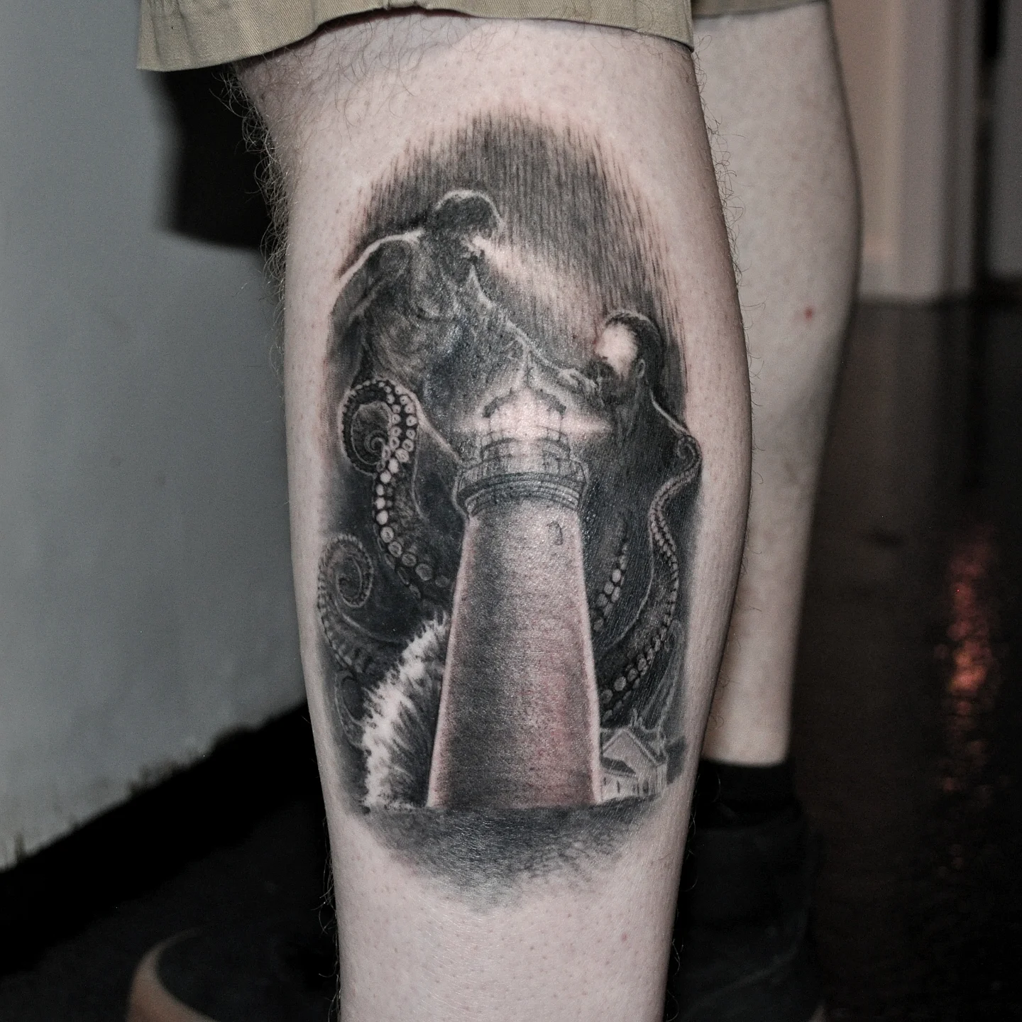 Octopus and lighthouse realism tattoo on the calf by Bek Artz