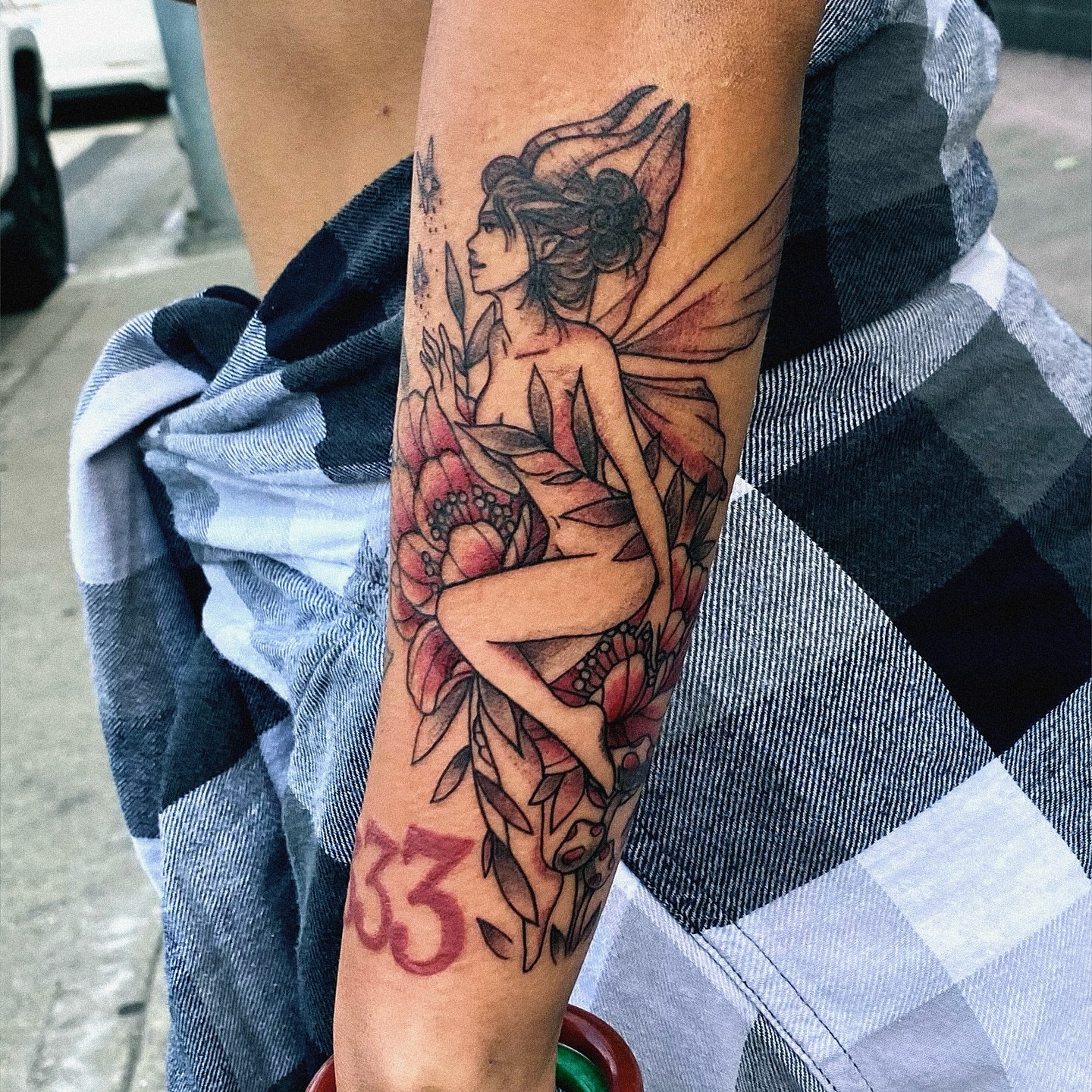 Fairy with flowers neo-traditional tattoo on the forearm by Mallory