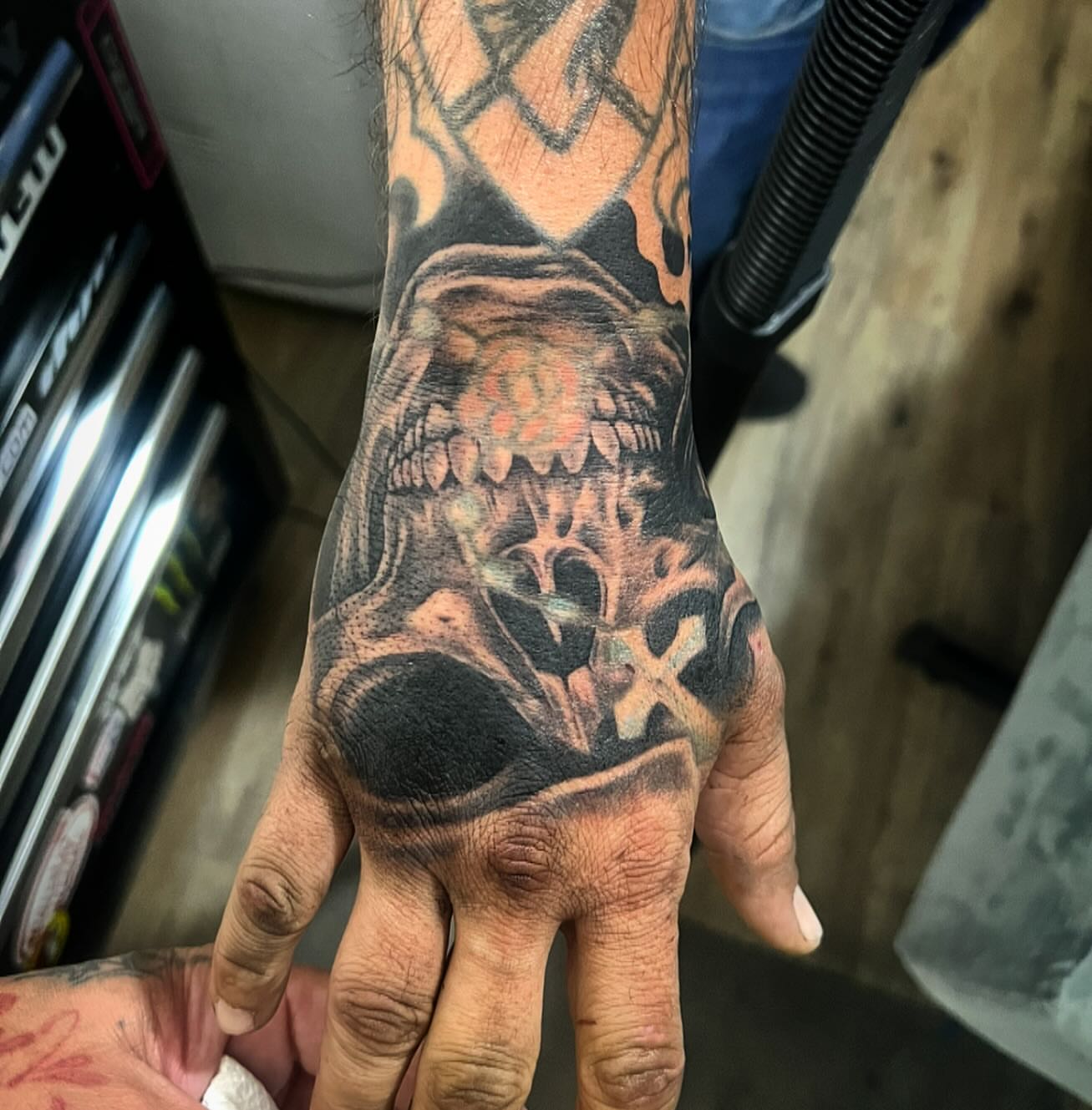 Skull dark realism tattoo on the hand by Jay