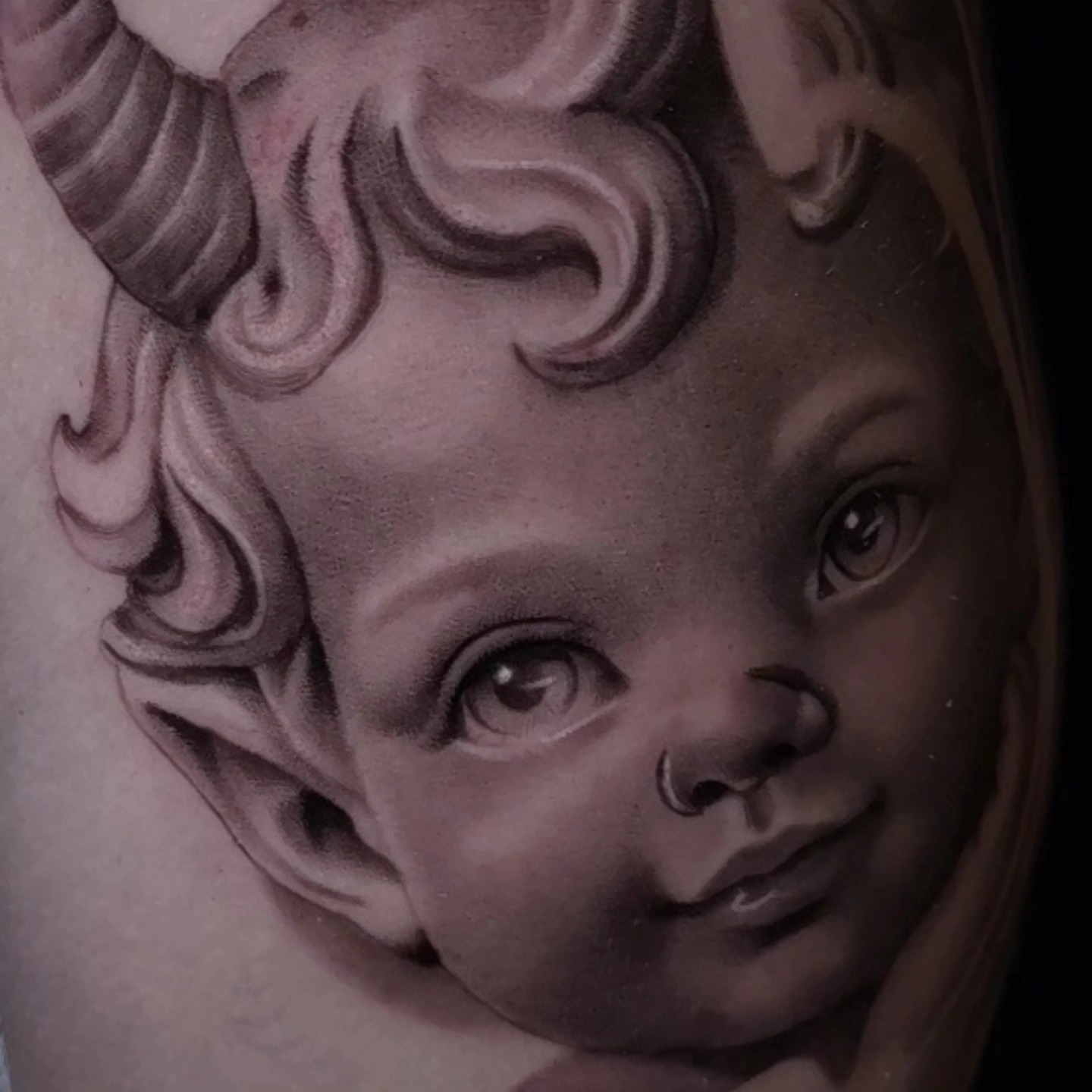 Child's face realism tattoo on the forearm by Ana Fajardo