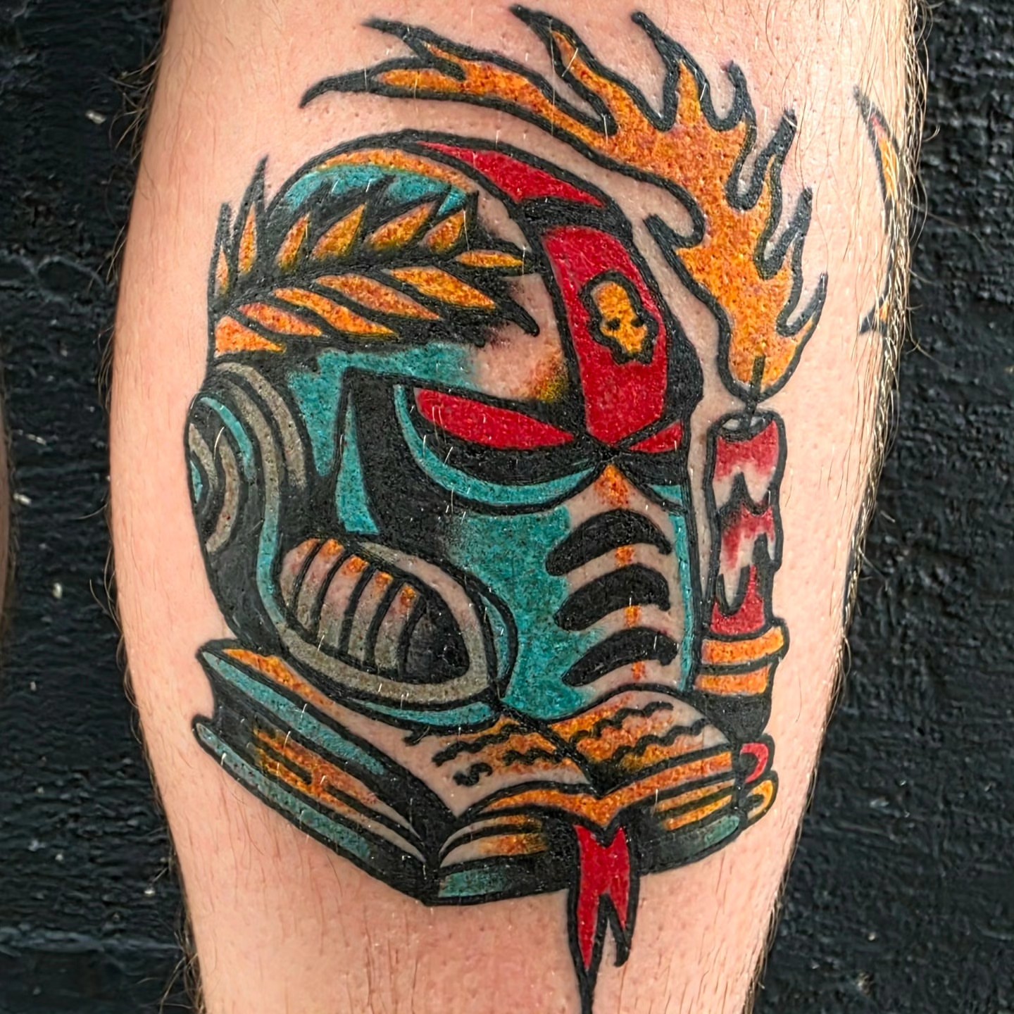 Mask with book American traditional tattoo on the forearm by Mitch Braver