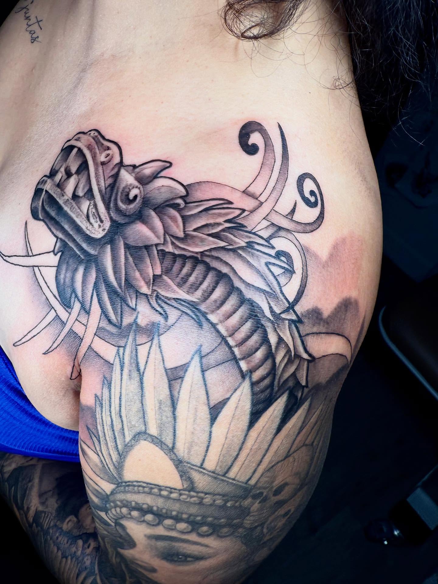 Dragon realism tattoo on the shoulder by Denver Tattoo Artist