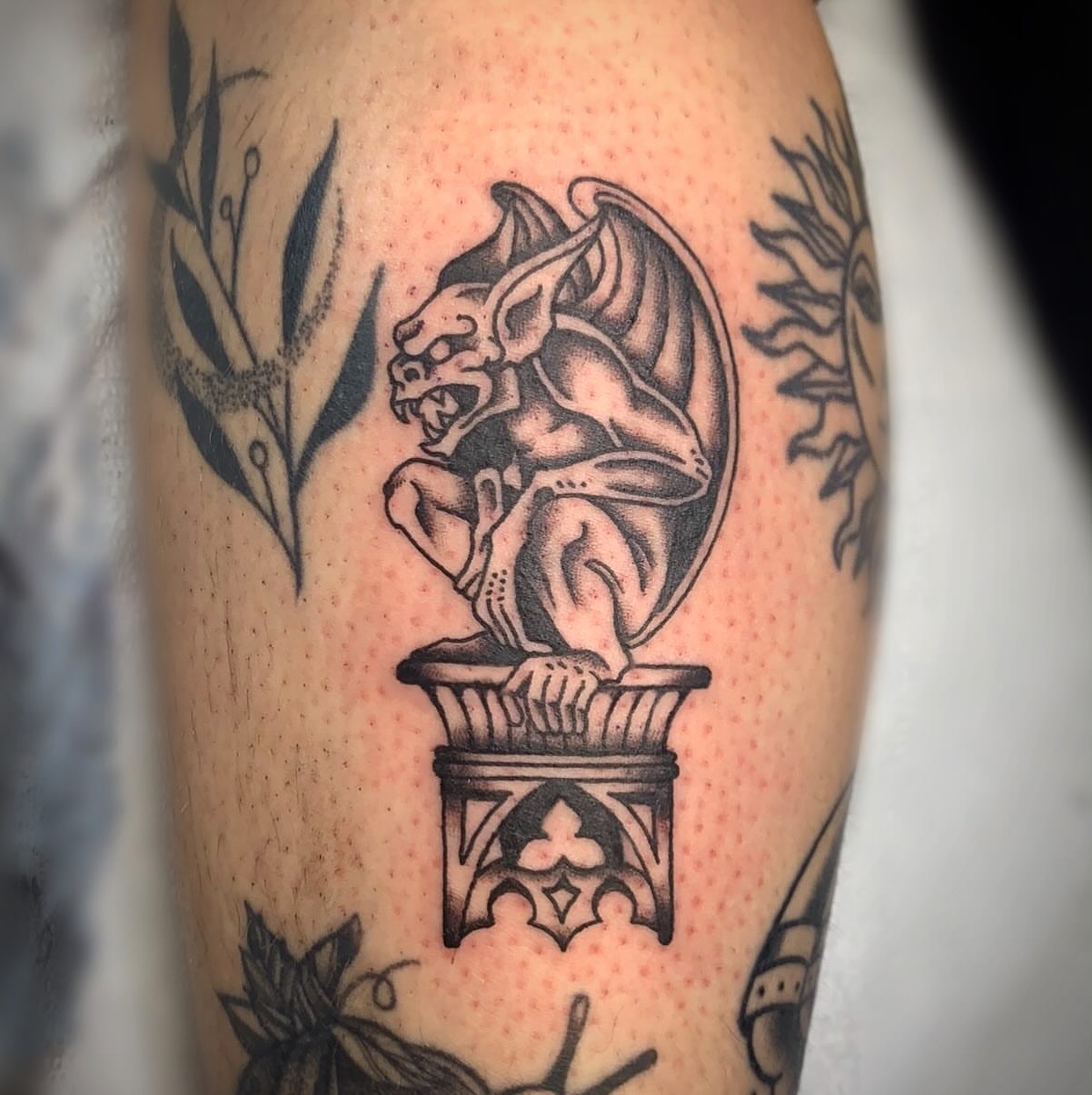 Gargoyle black and grey tattoo on the forearm by Ava Glory Tattoos