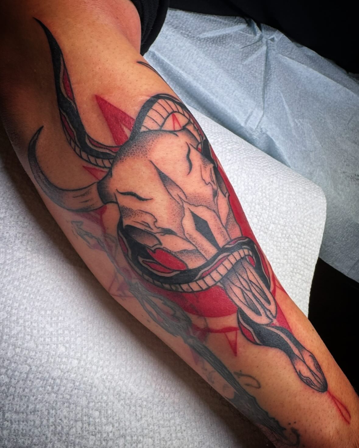Bull and snake American traditional tattoo on the forearm by Paul Giovis