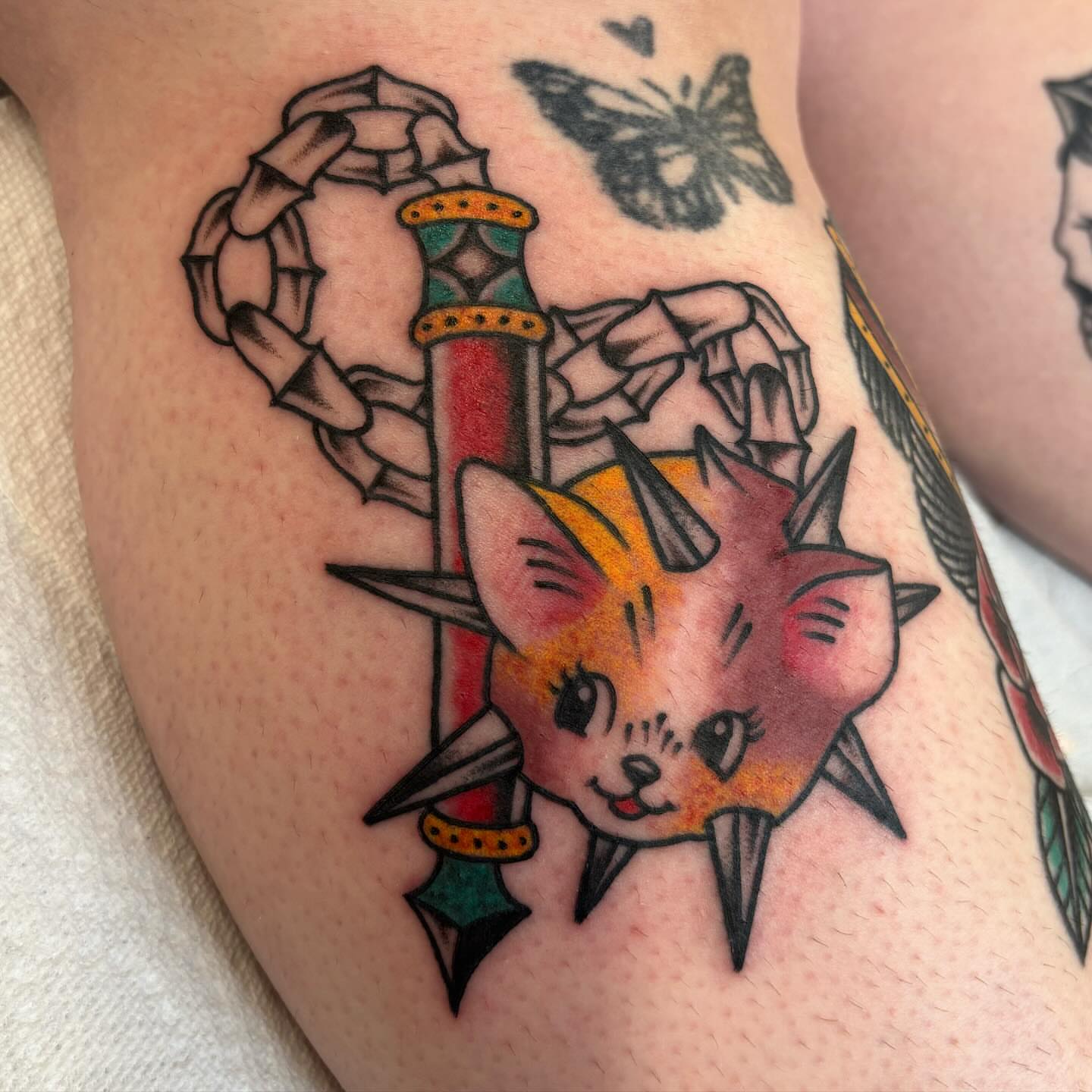 Cat with dagger American traditional tattoo on the thigh by Brandi ⛓, Detroit, Michigan