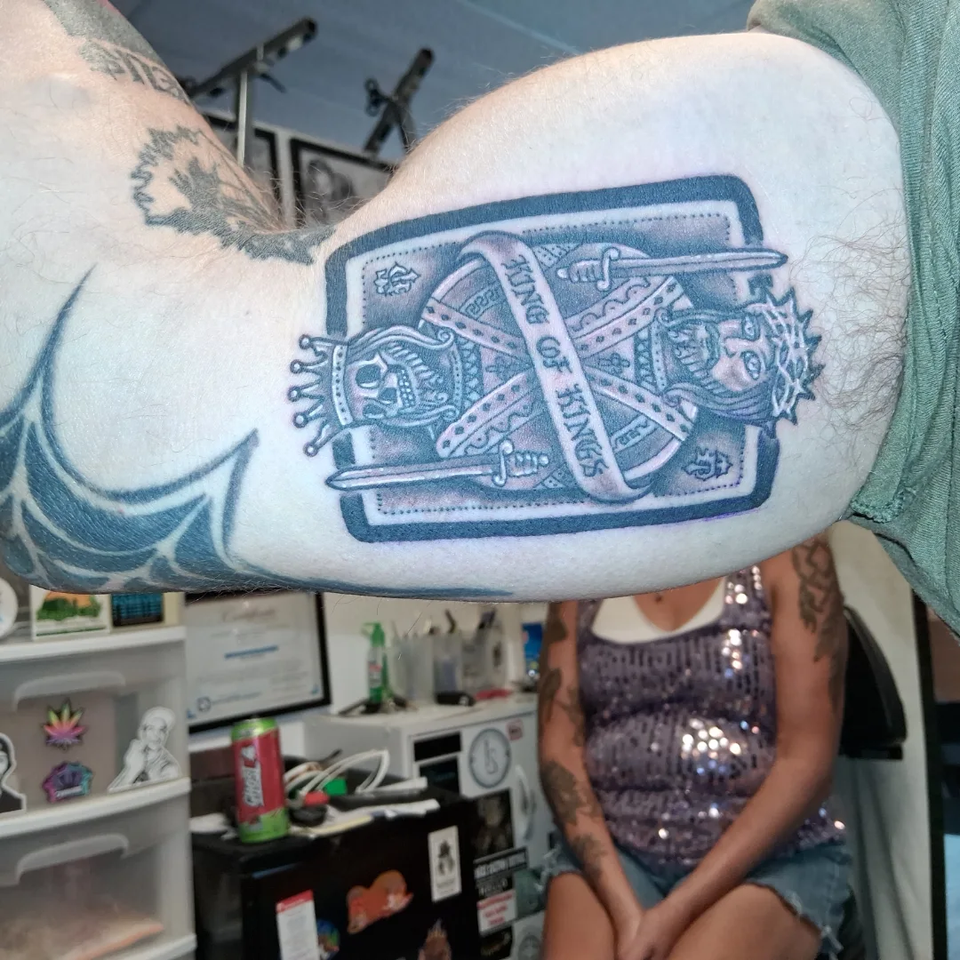 King of kings card American traditional tattoo on the forearm by Dave Johnson, Billings, Montana