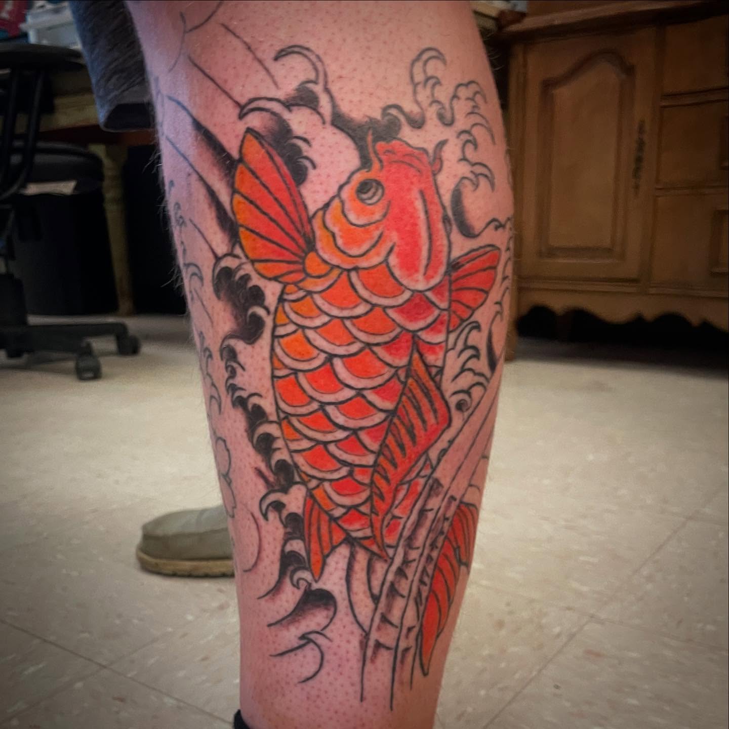 Koi fish dotwork tattoo on the calf by Logan Casimir