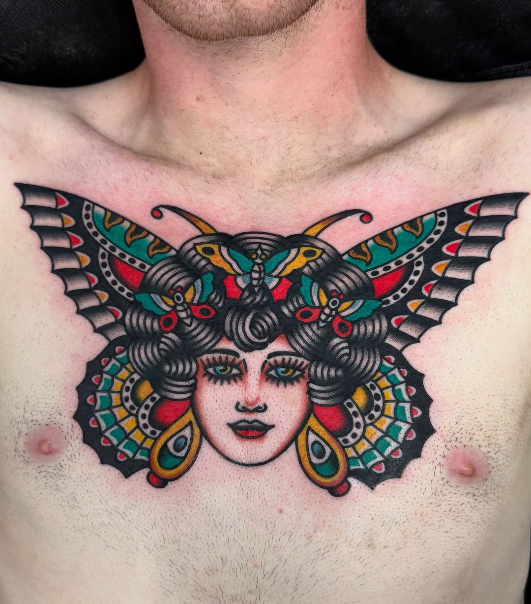 Woman with butterfly wings neo-traditional tattoo on the chest by Joey Burdette Tattoos