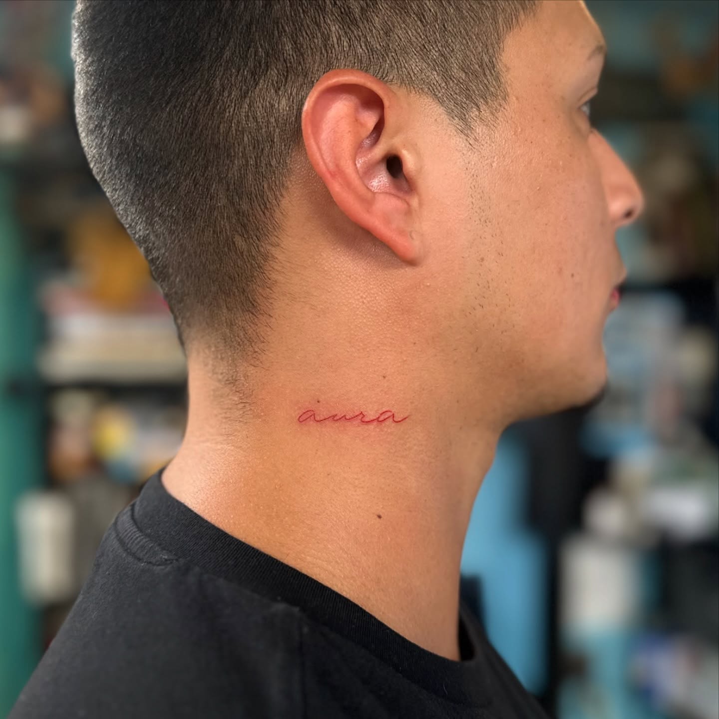 Aura lettering script tattoo on the neck by Savy Rasor, Austin, Texas