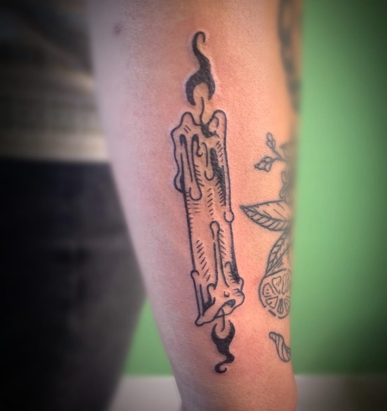 Candle black and grey tattoo on the forearm by Ava Glory Tattoos