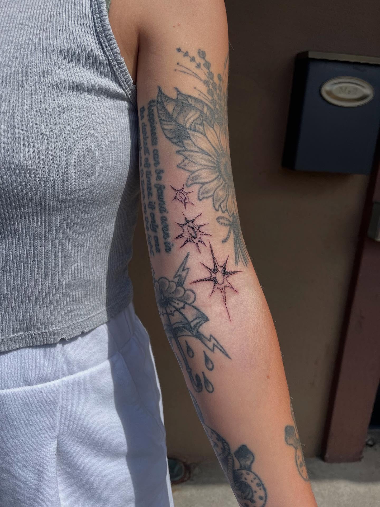 Lotus flower and stars neo-traditional tattoo on the forearm by J❄️, Portland, Oregon