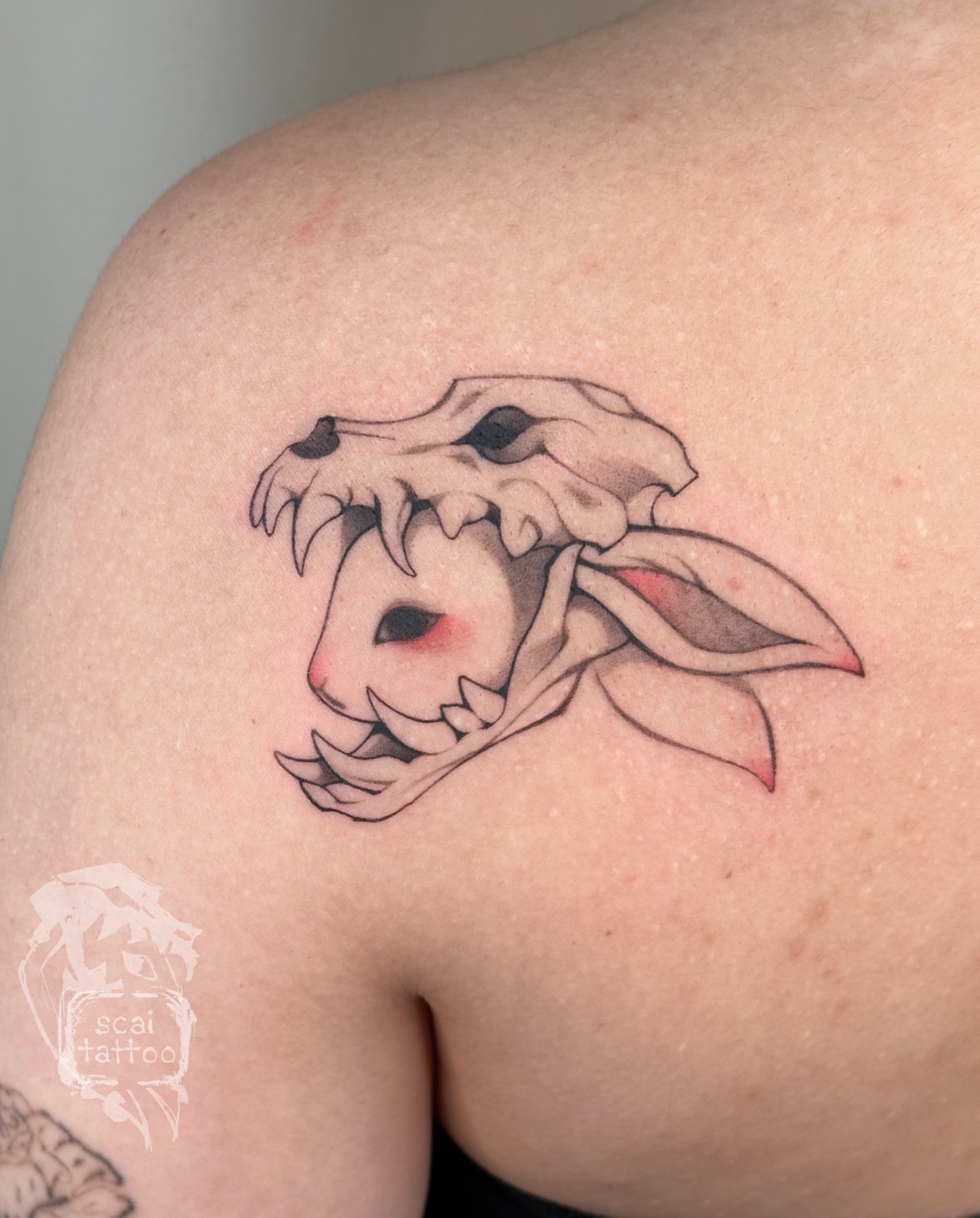 Skull with rabbit ears neo-traditional tattoo on the shoulder by scaitattoo