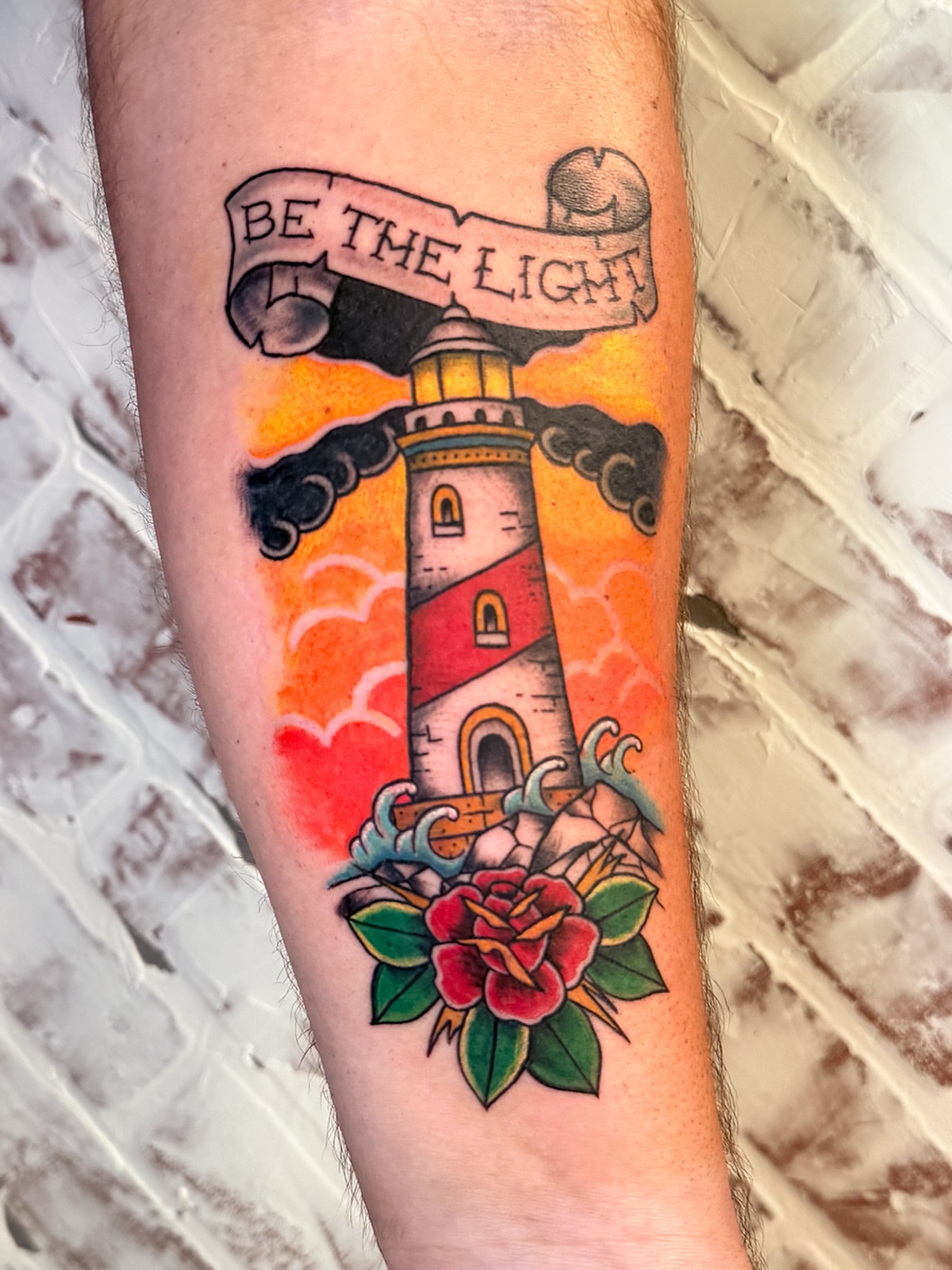 Lighthouse and banner American traditional tattoo on the forearm by Brandt Norcross