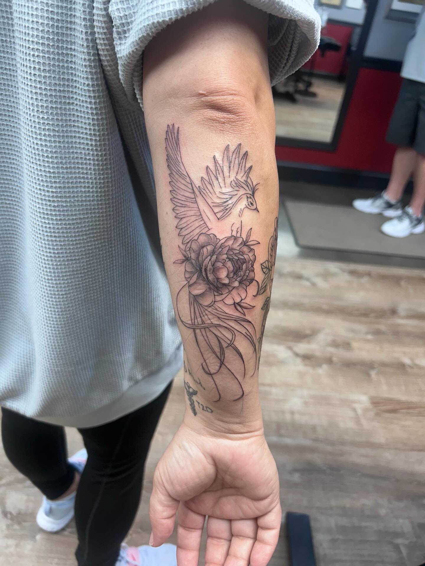 Bird and flower black and grey tattoo on the forearm by Ricardo (RJ)