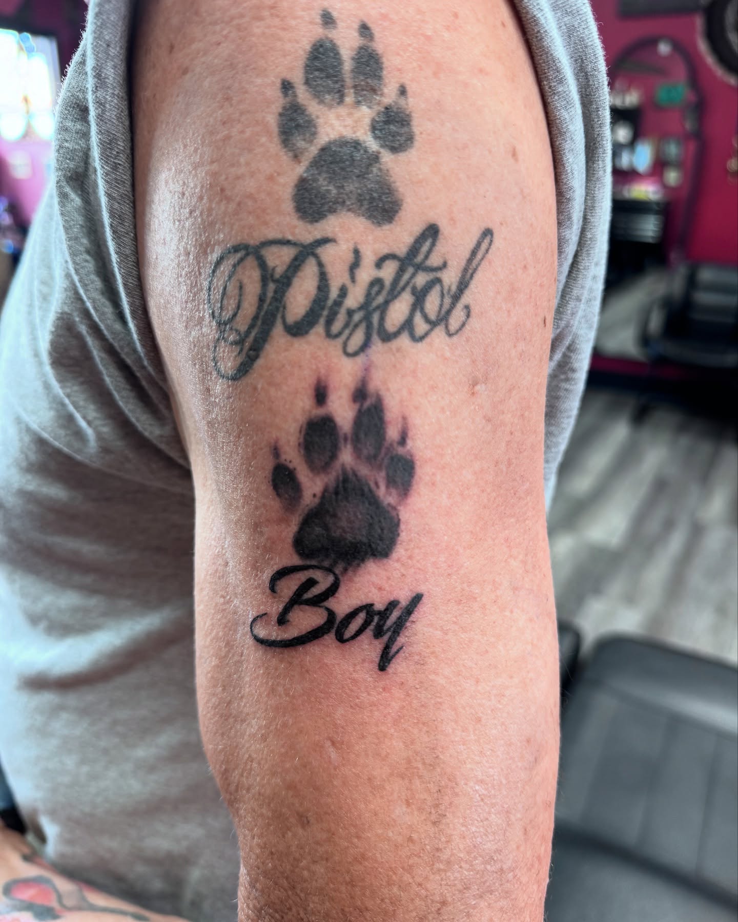 Paw prints and script black and grey tattoo on the forearm by Ryland - Tattoo Artist