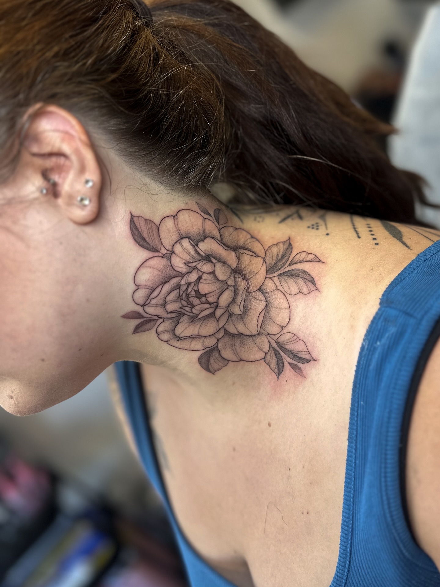 Peony black and grey tattoo on the neck by Priscilla Michels