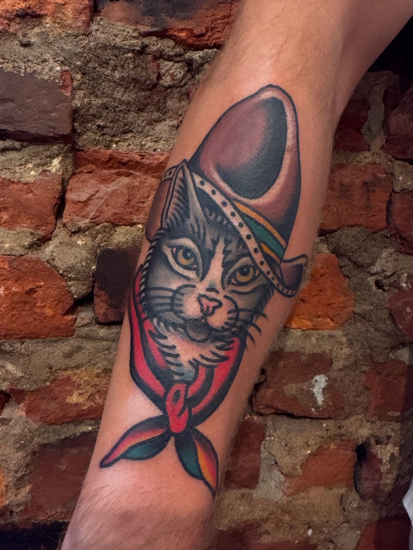 Cat wearing cowboy hat American traditional tattoo on the forearm by Tony Kaplan
