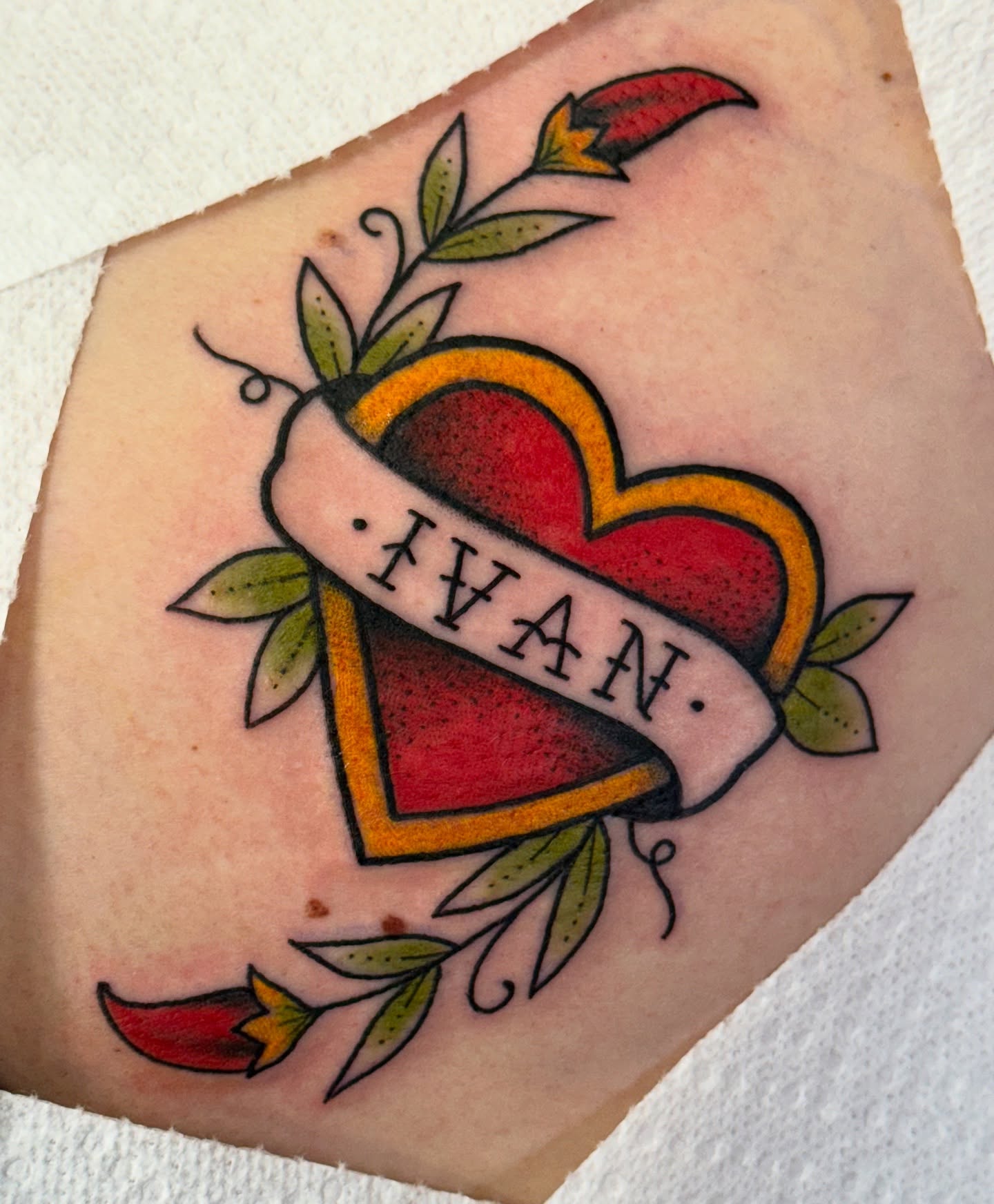 Heart with name banner American traditional tattoo on the forearm by jenna clark🎨