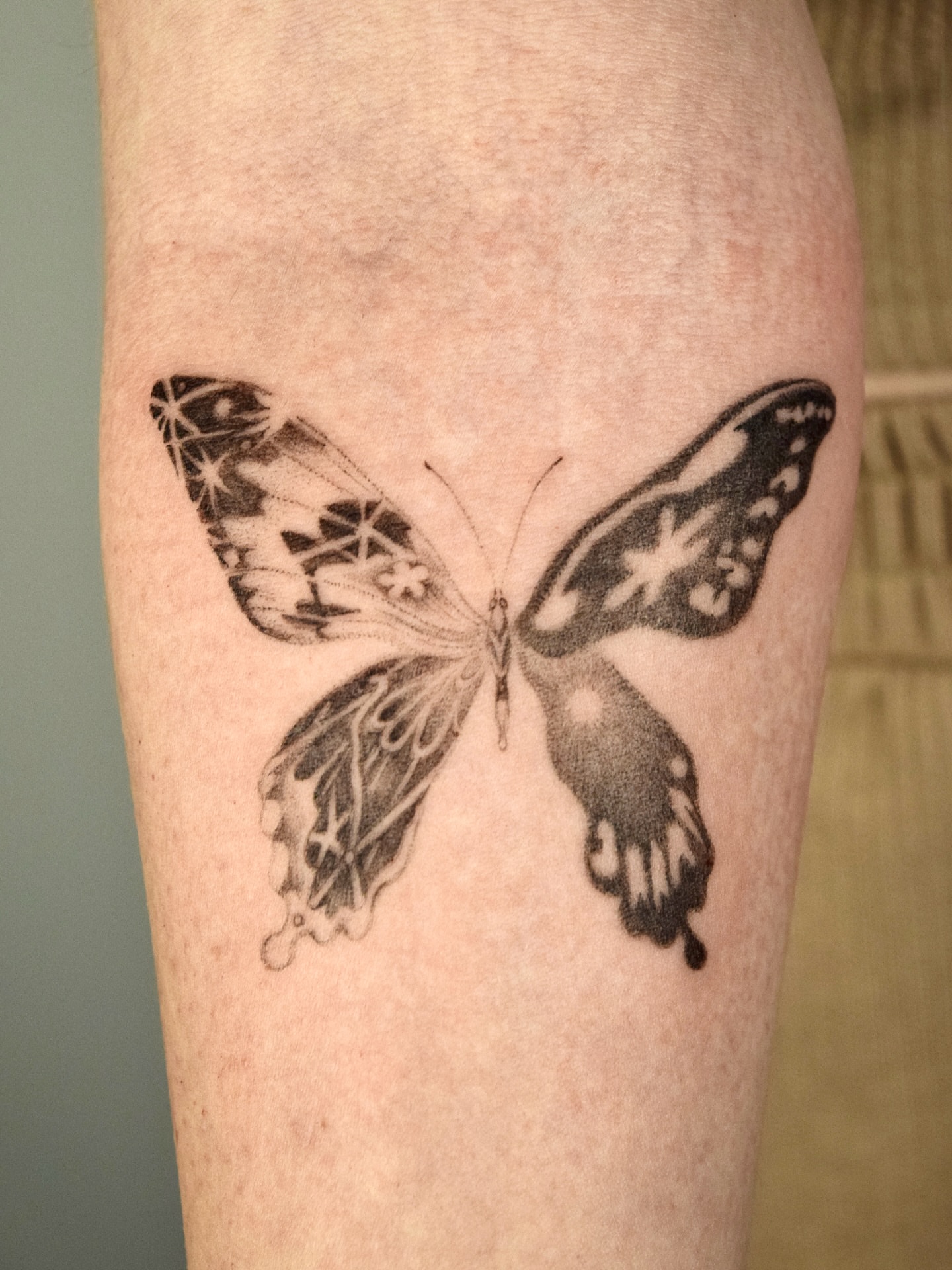 Butterfly black and grey tattoo on the forearm by Stella Oh