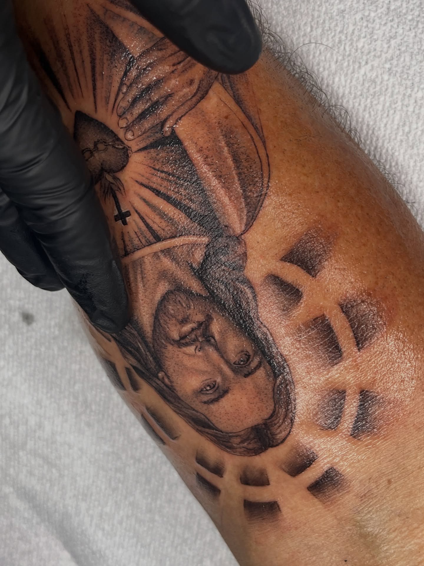 Religious figure black and grey tattoo on the forearm by Dotwork