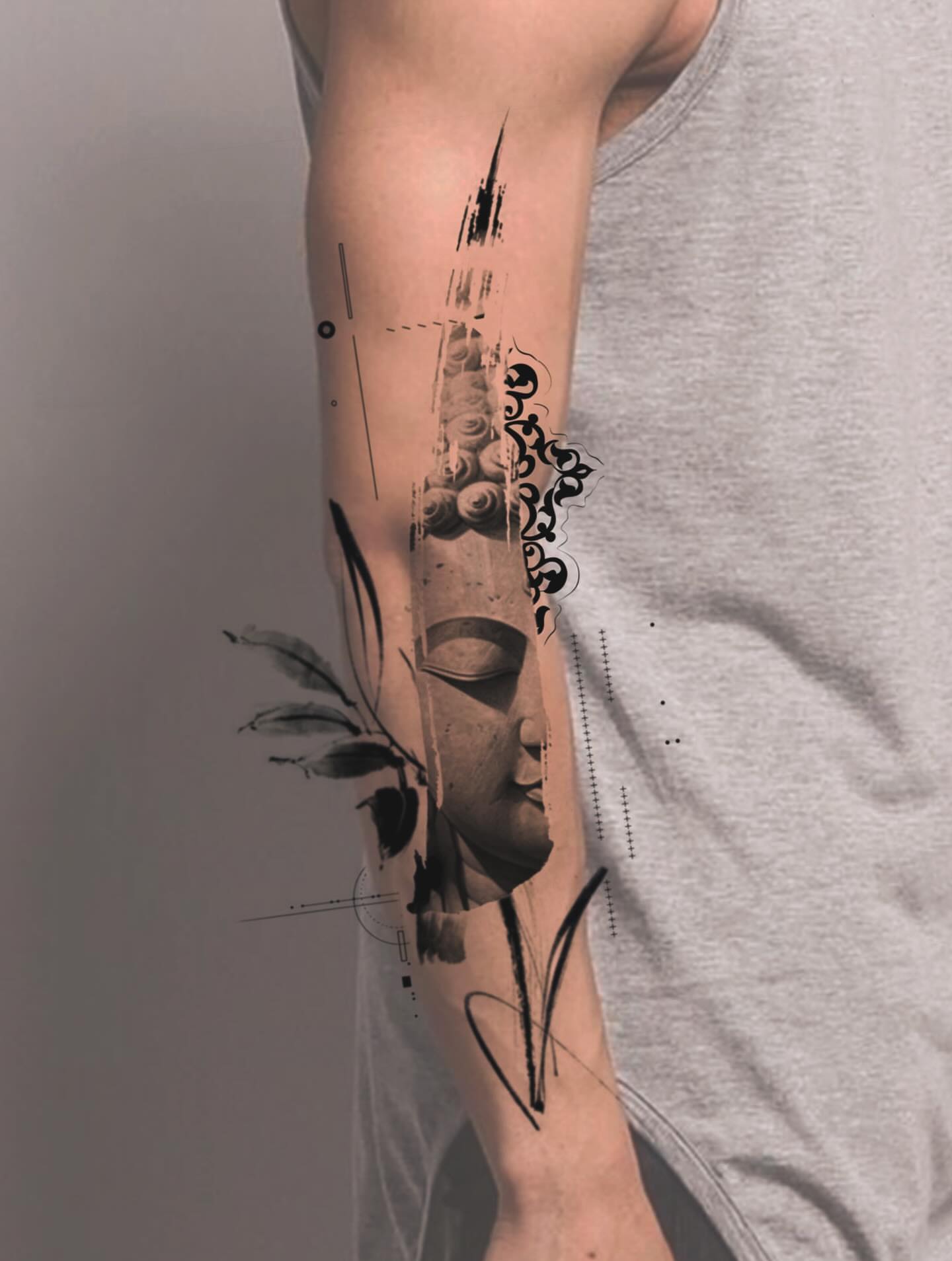 Buddha head geometric tattoo on the forearm by Aren