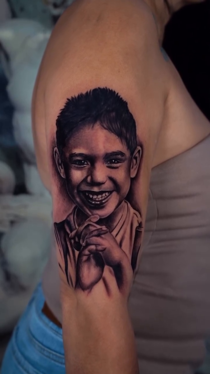 Portrait of a young boy realism tattoo by Danny Rodriguez