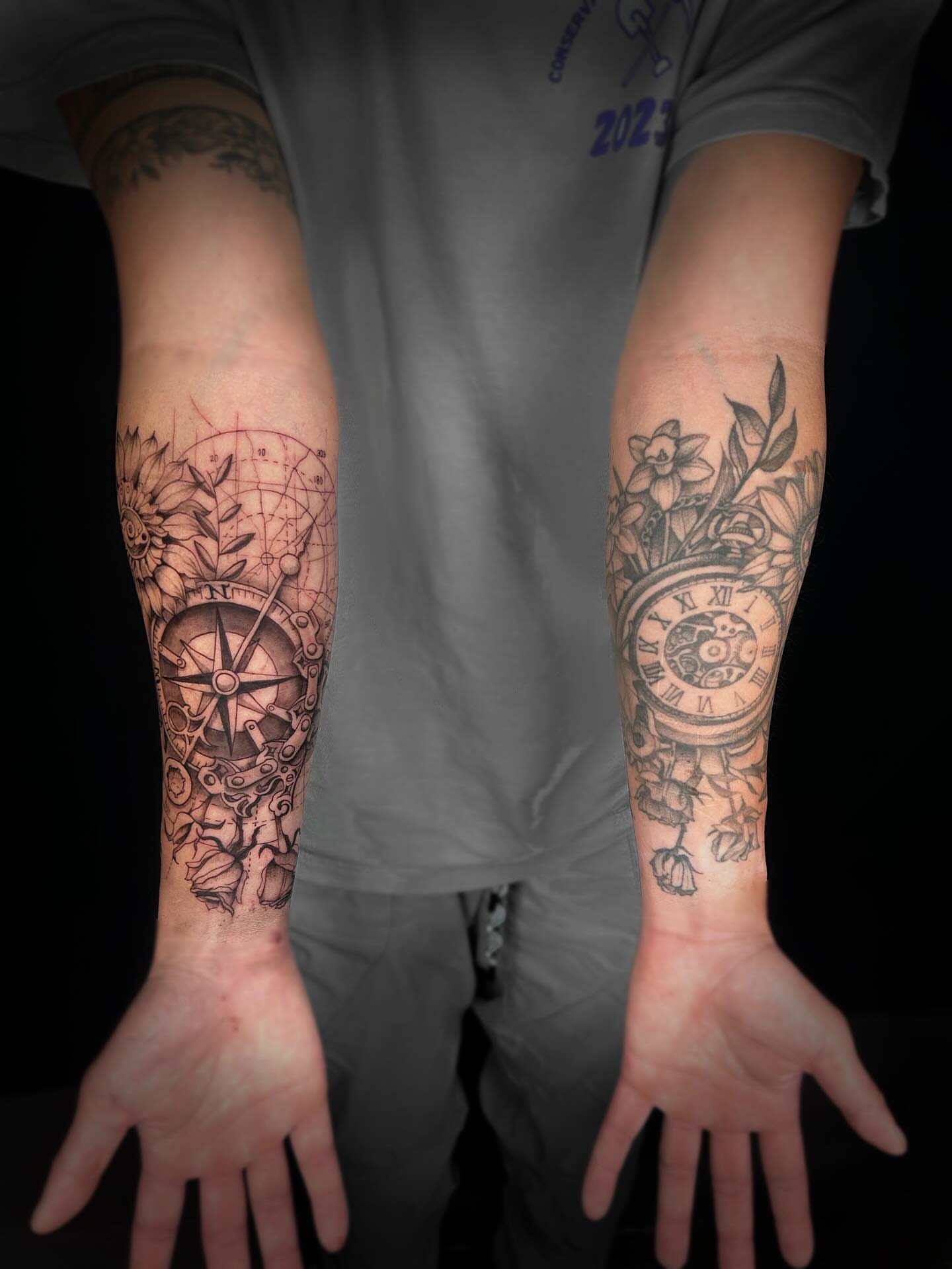 Compass and floral arrangement realism tattoo on the forearm by Kipling Mcclellan