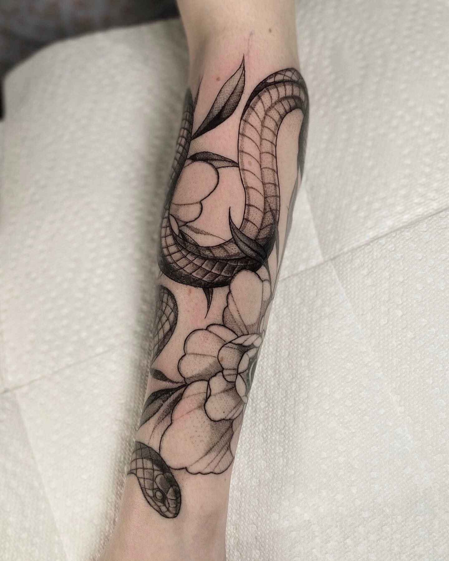 Snake and peony realism tattoo on the forearm by jada