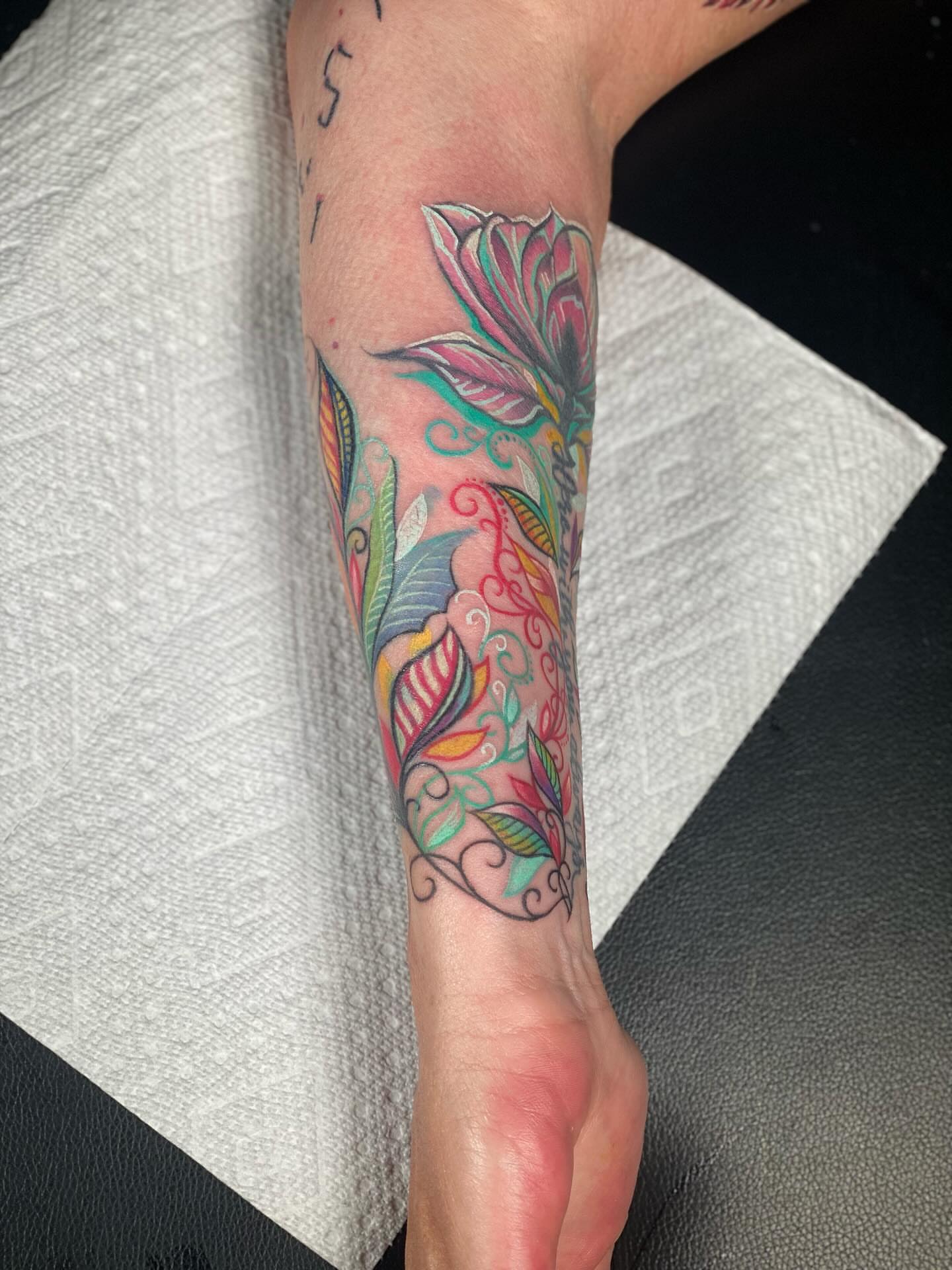 Floral design new school tattoo on the forearm by Chris Klee